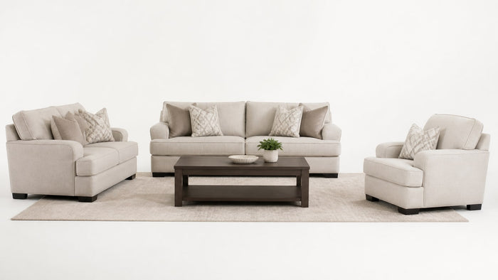 Coordinated living room furniture set including sofa, loveseat, chair, coffee table, and rug on white background