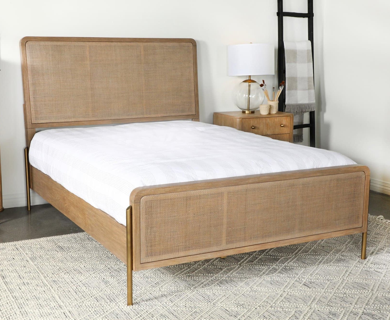 Arini Upholstered Eastern King Panel Bed front view showing sand wash finish and natural cane headboard