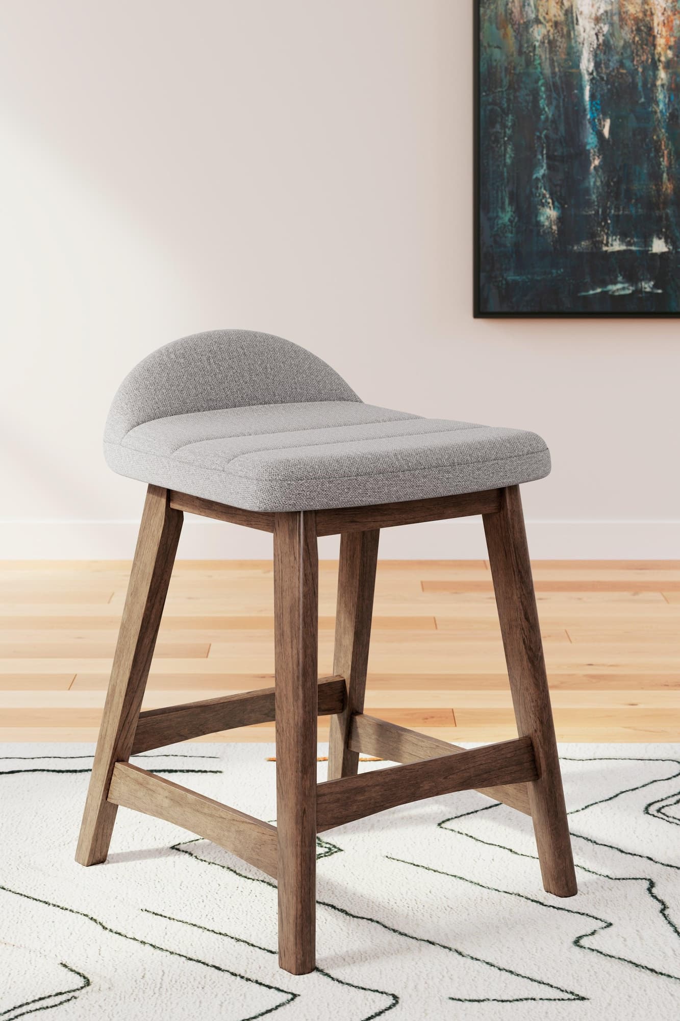 Lyncott counter height bar stool side view showing light gray upholstered seat and brown wood frame
