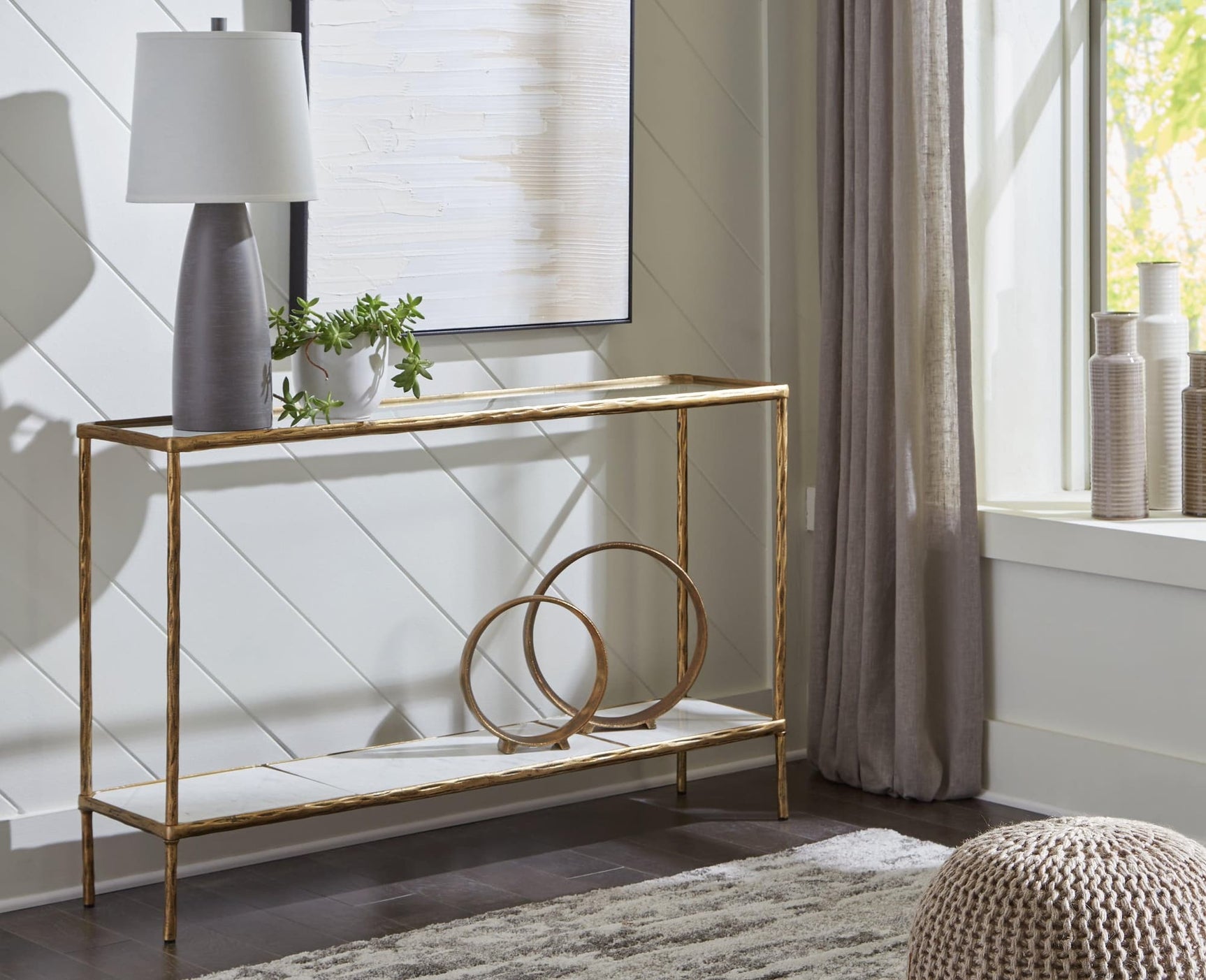 Ryandale Console Sofa Table side view showing antique brass finish and marble shelf