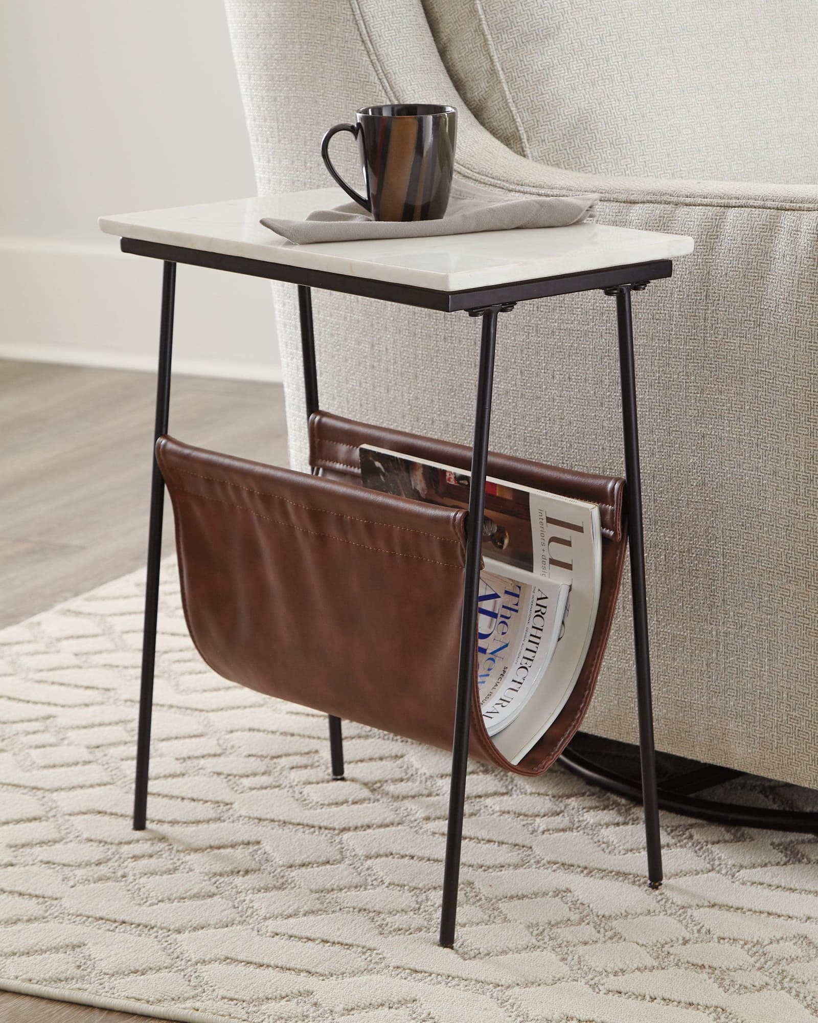 Etanbury Accent Table front angle showing white marble tabletop and brown faux leather magazine holder