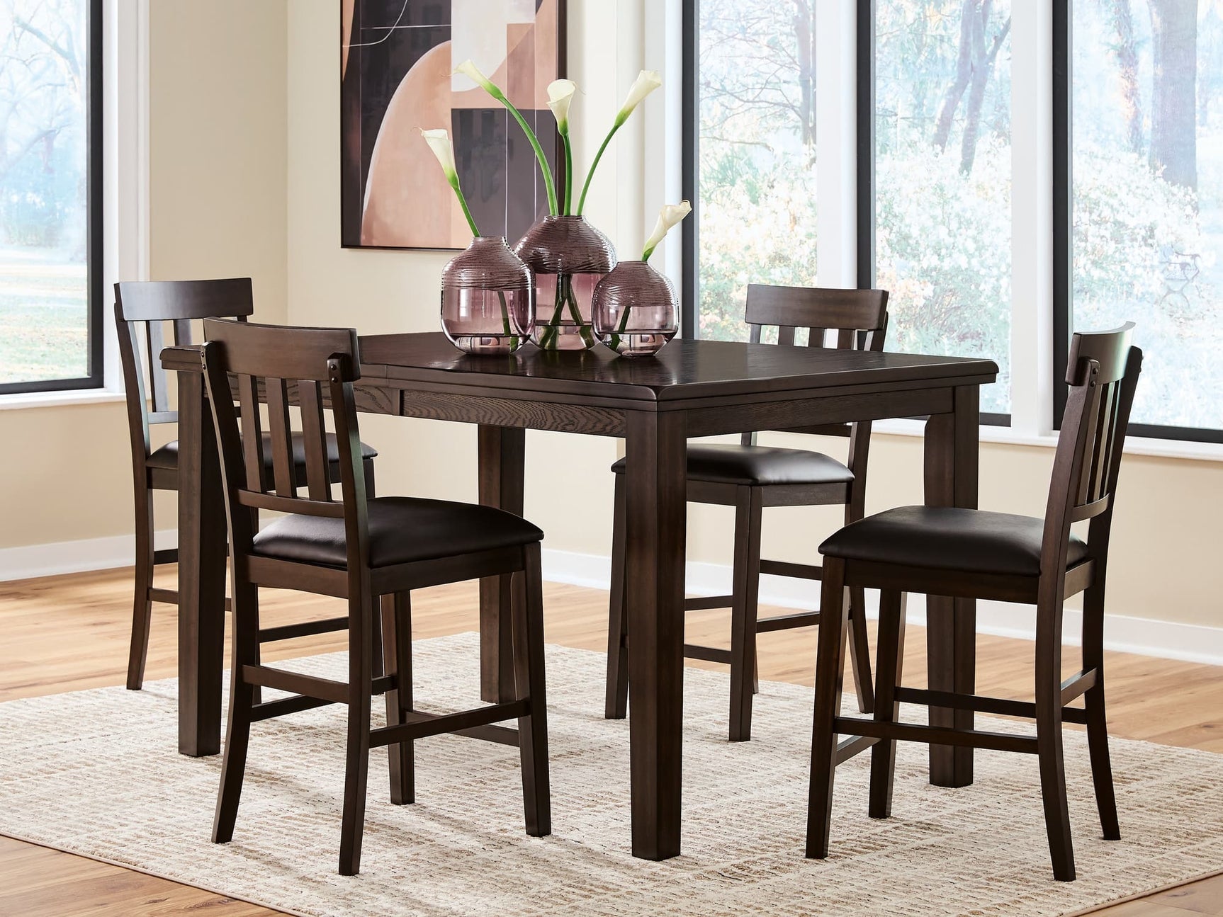 Haddigan dark brown counter height dining table with four barstools - front view
