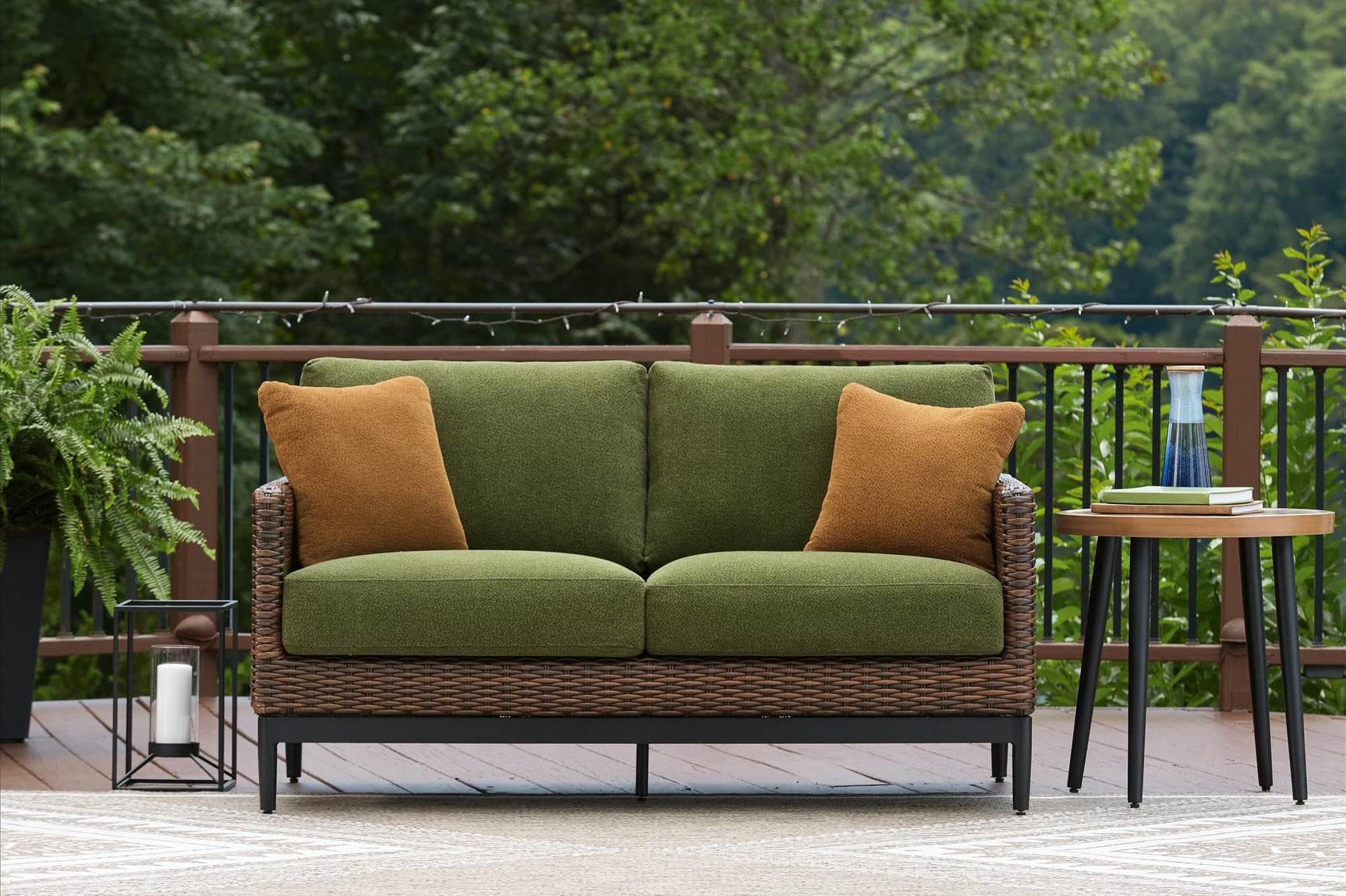 Horizon Hall brown and green outdoor loveseat front angle