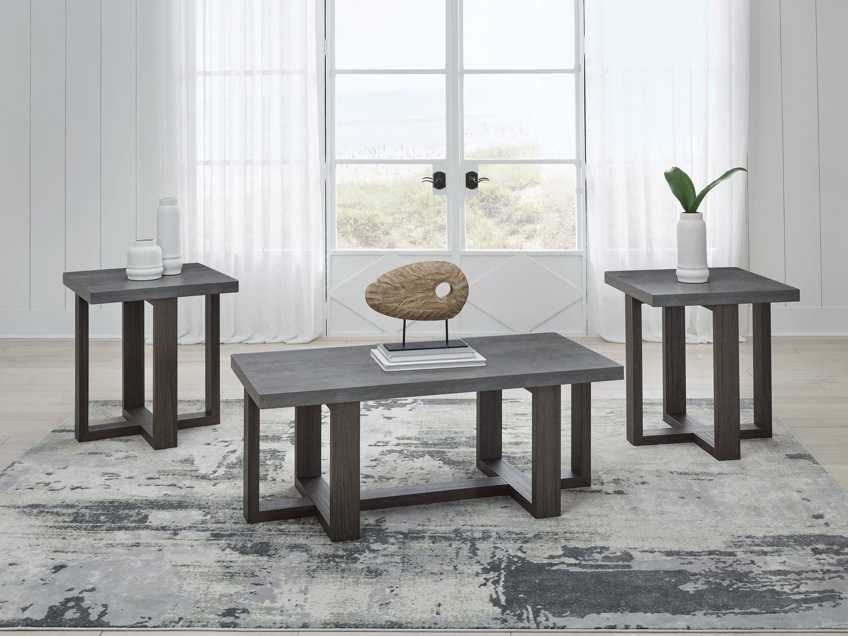 Dynnford 3-piece table set with faux soapstone tops and dark wood legs - front view