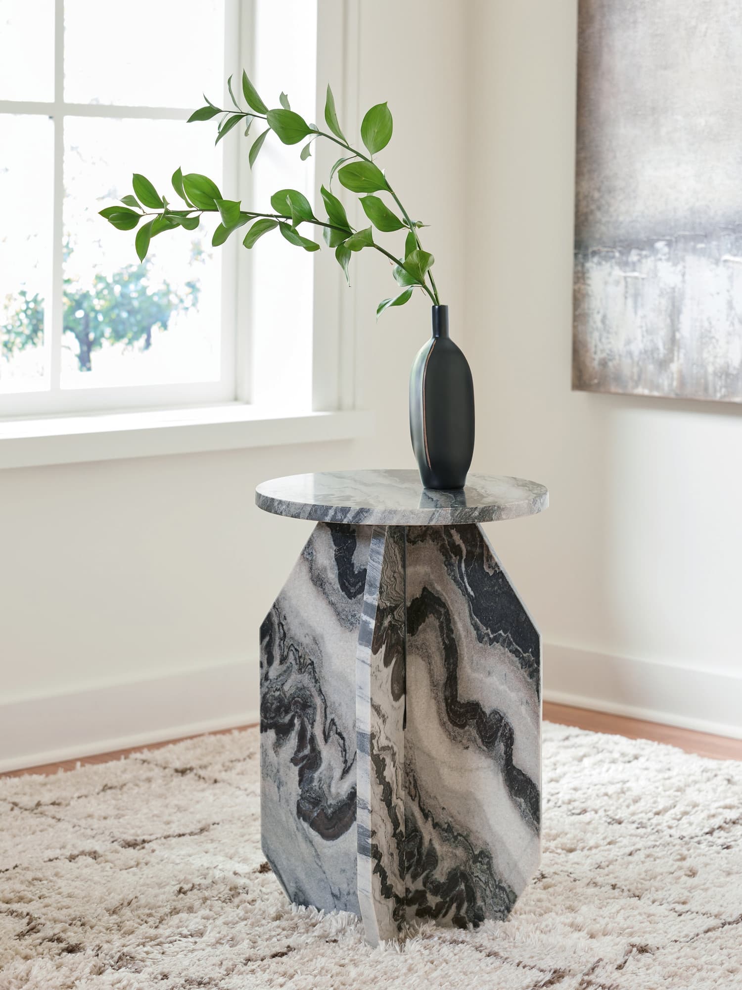 Wrenlane round marble accent table showing top and sculptural base