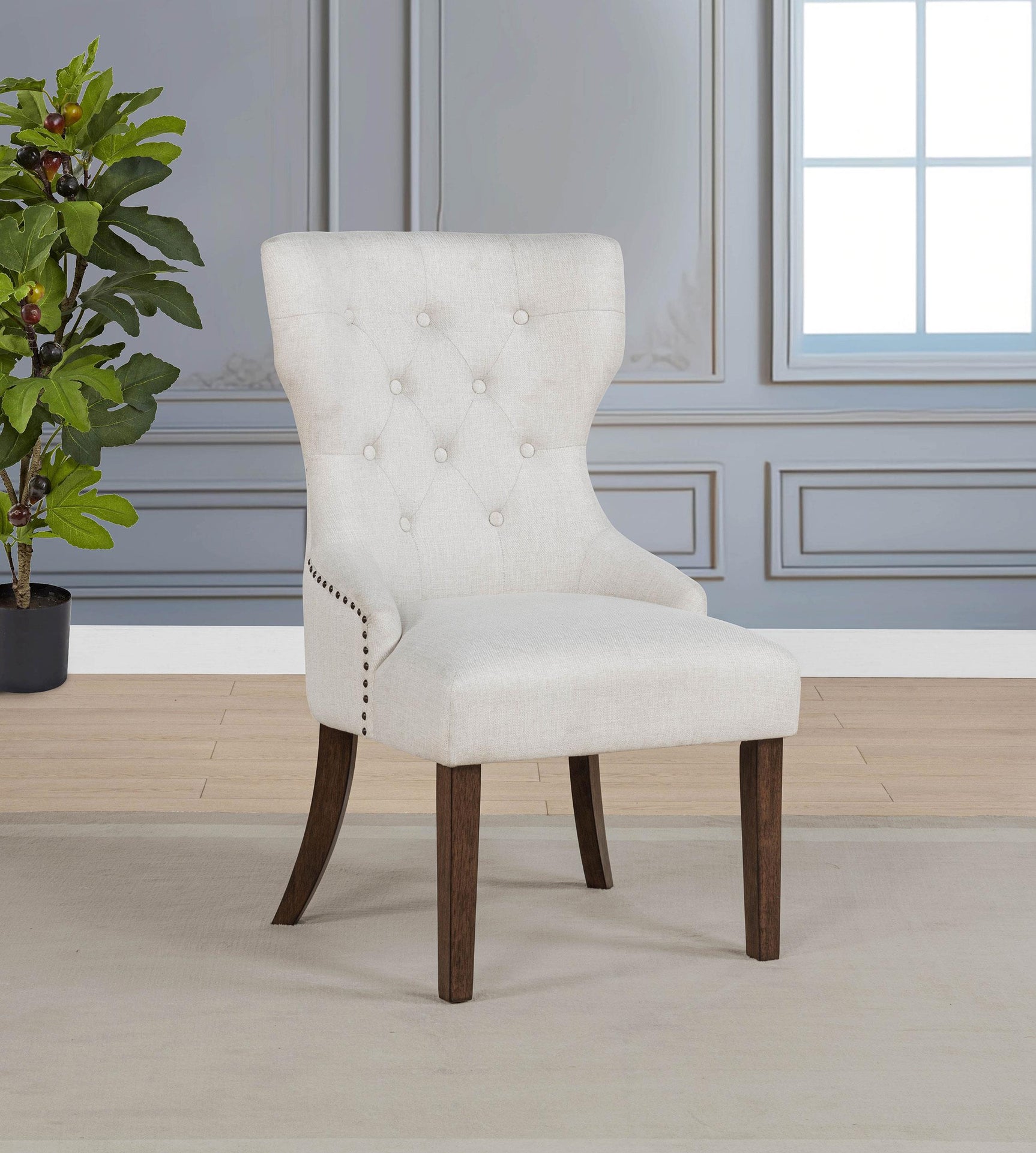 Side angle of Baney cream fabric upholstered wingback dining chair