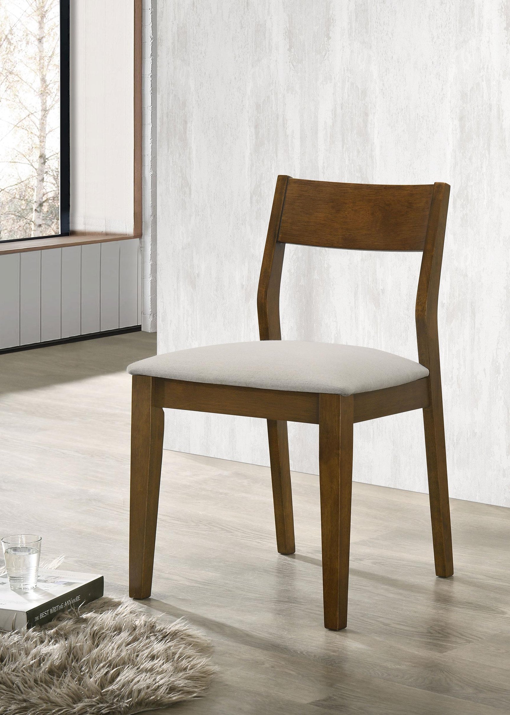 Side angle of Almonte dining chair showing fabric upholstery and wooden legs