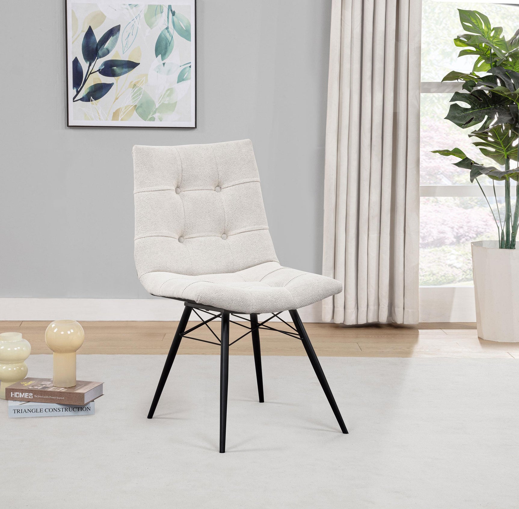 Aiken chair side view showing tufted back and metal legs