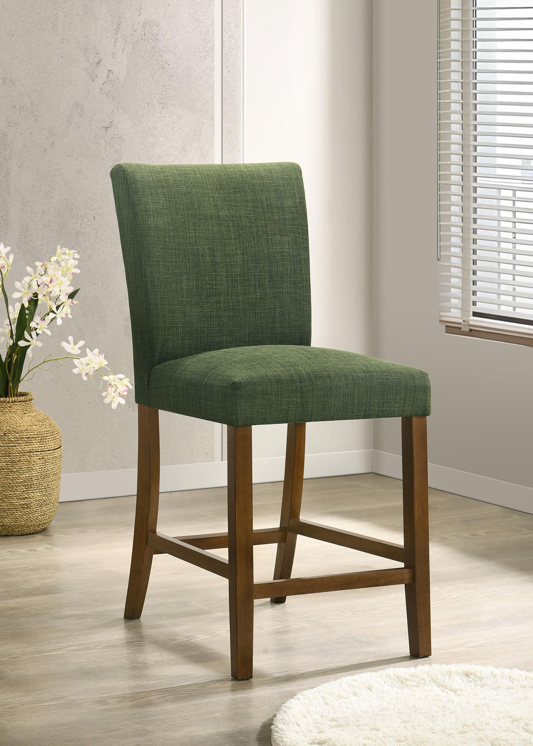 Paxton green upholstered dining chair with rubberwood frame detail