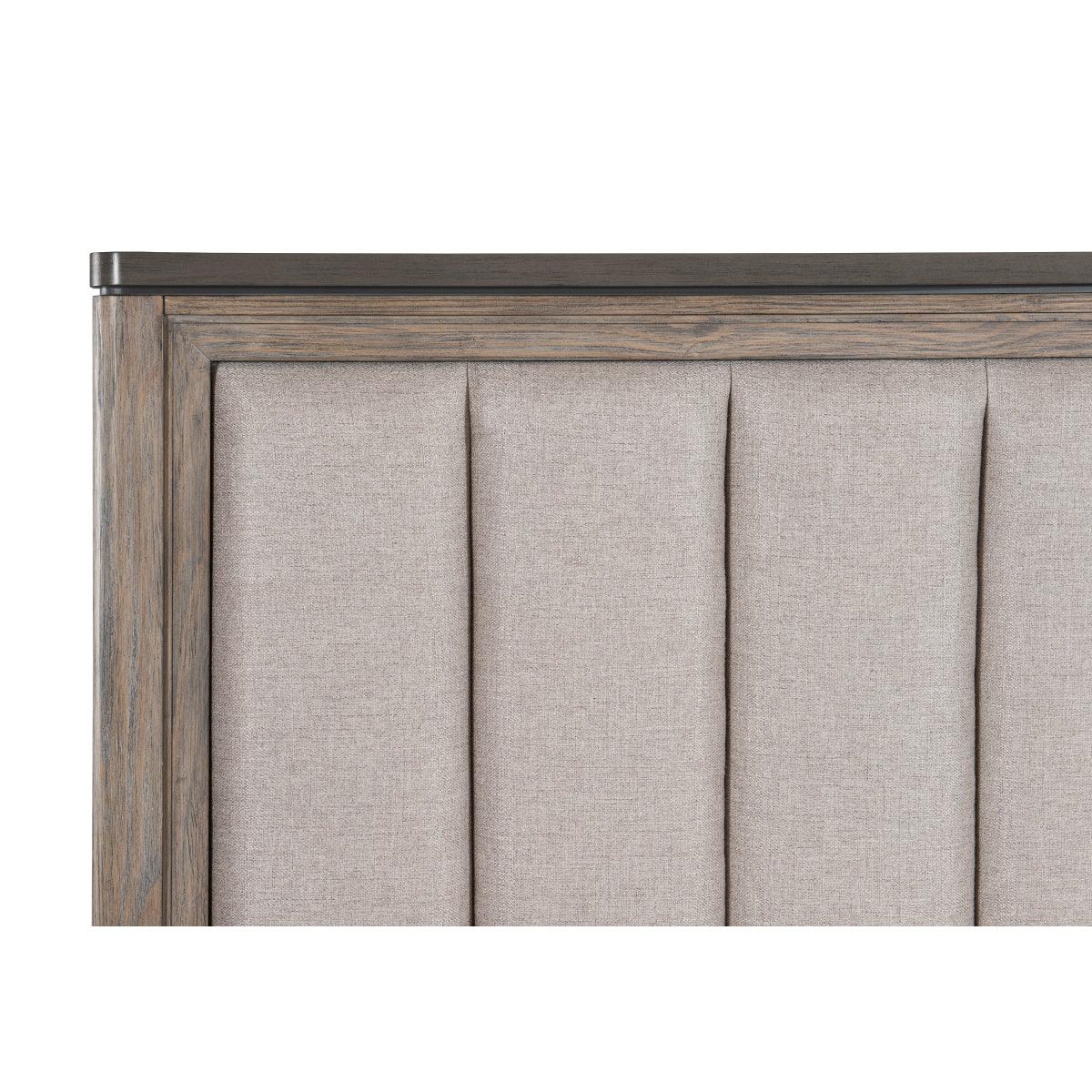 Close-up of Newell bed's light brown textured fabric headboard