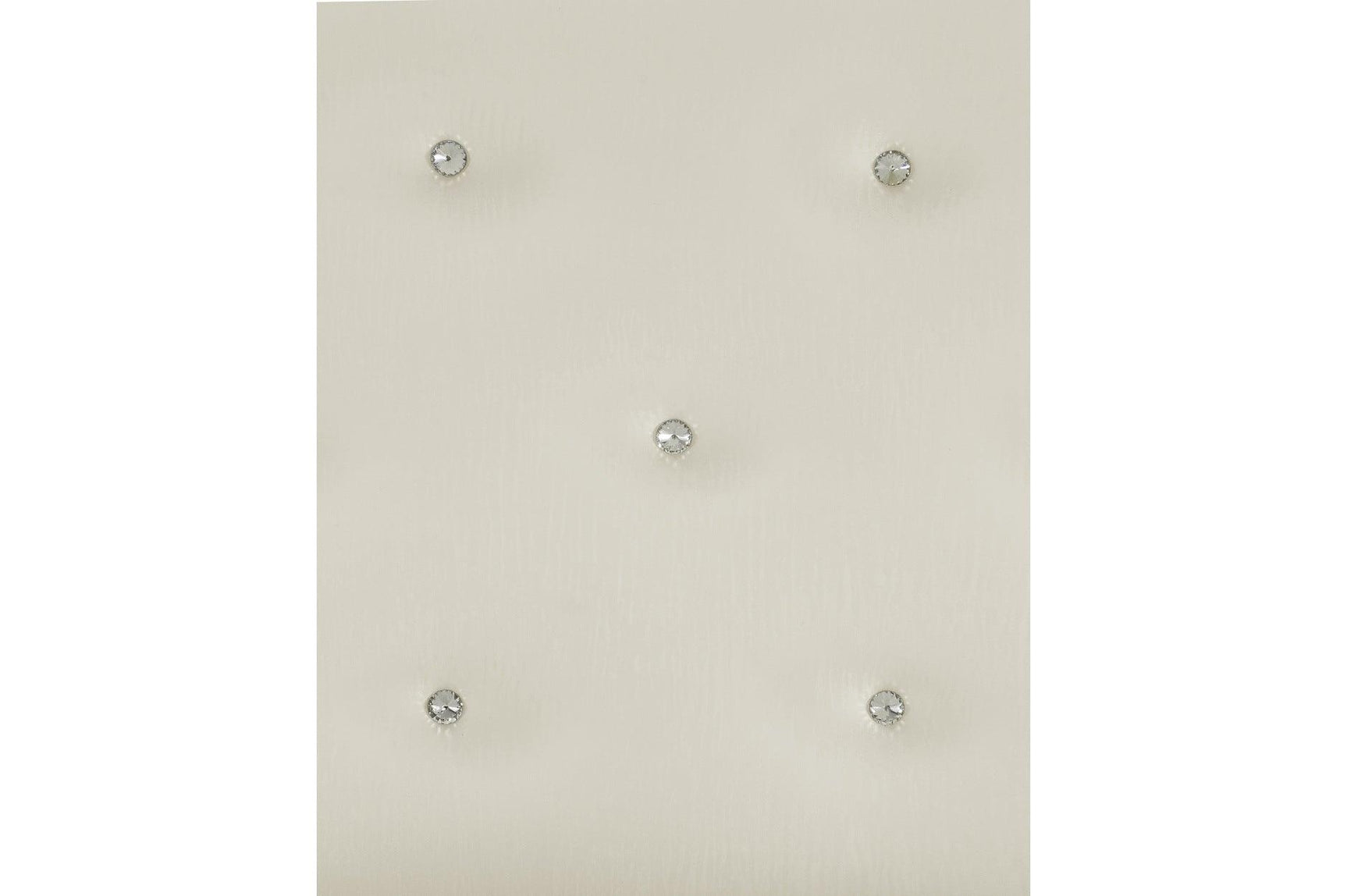 Close-up of white faux leather tufted headboard