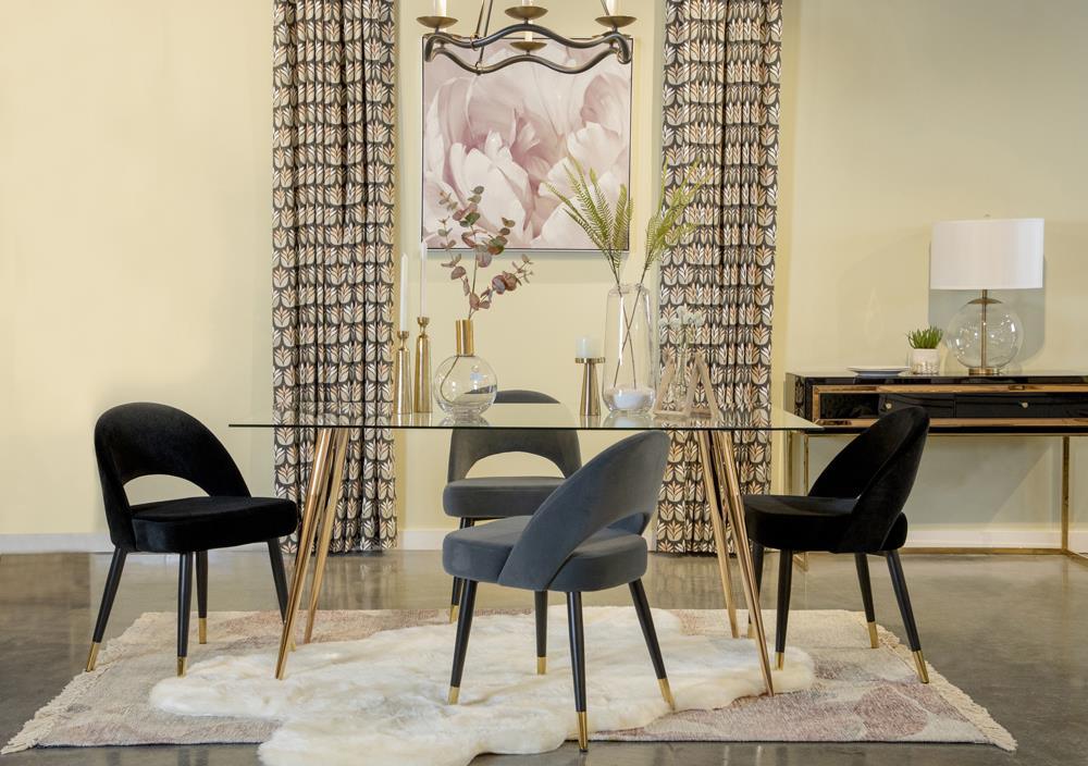 Modern dining table with glass top and black metal frame, view from side