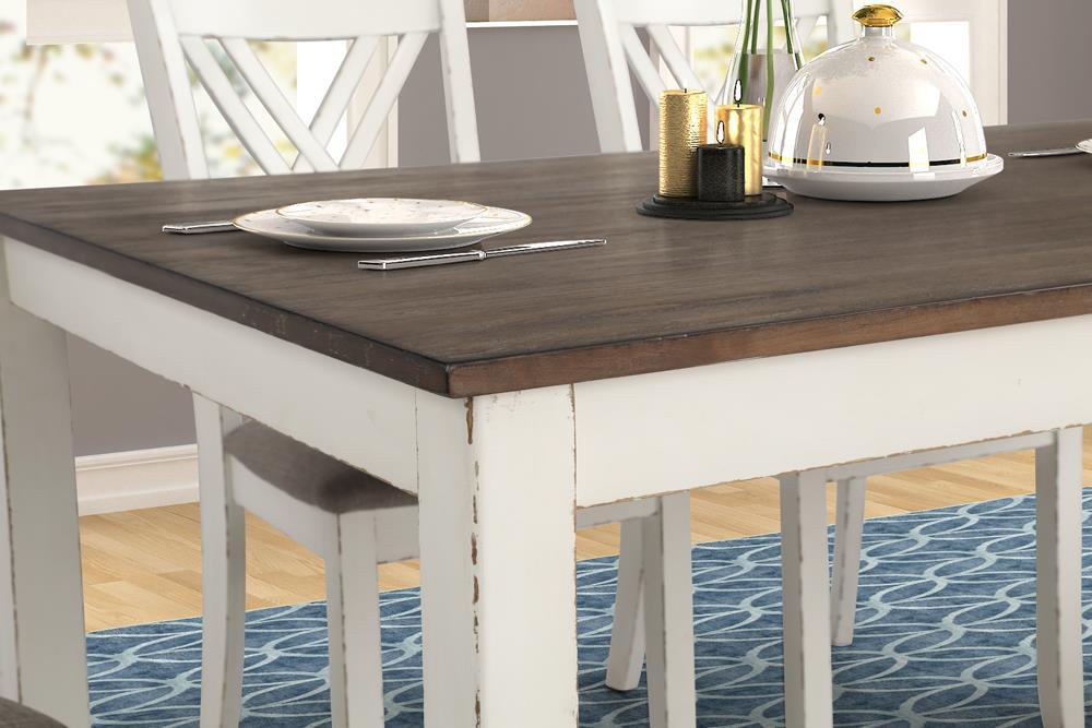 Close-up detail of chestnut table surface and vintage white legs