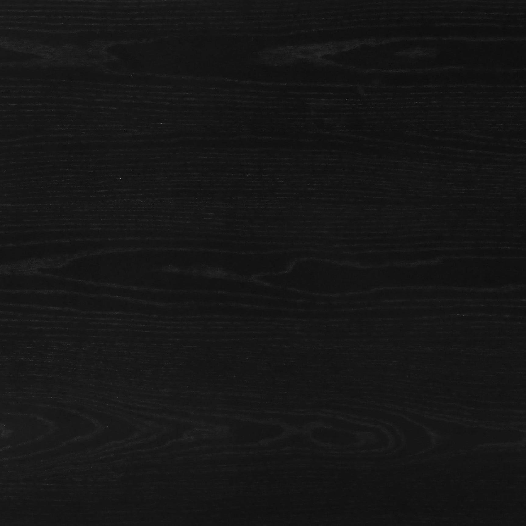 Black wood dining table styled in modern kitchen