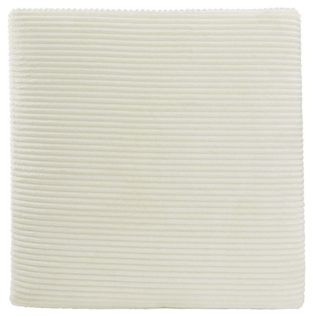 Close-up of ivory velvet fabric texture on ottoman