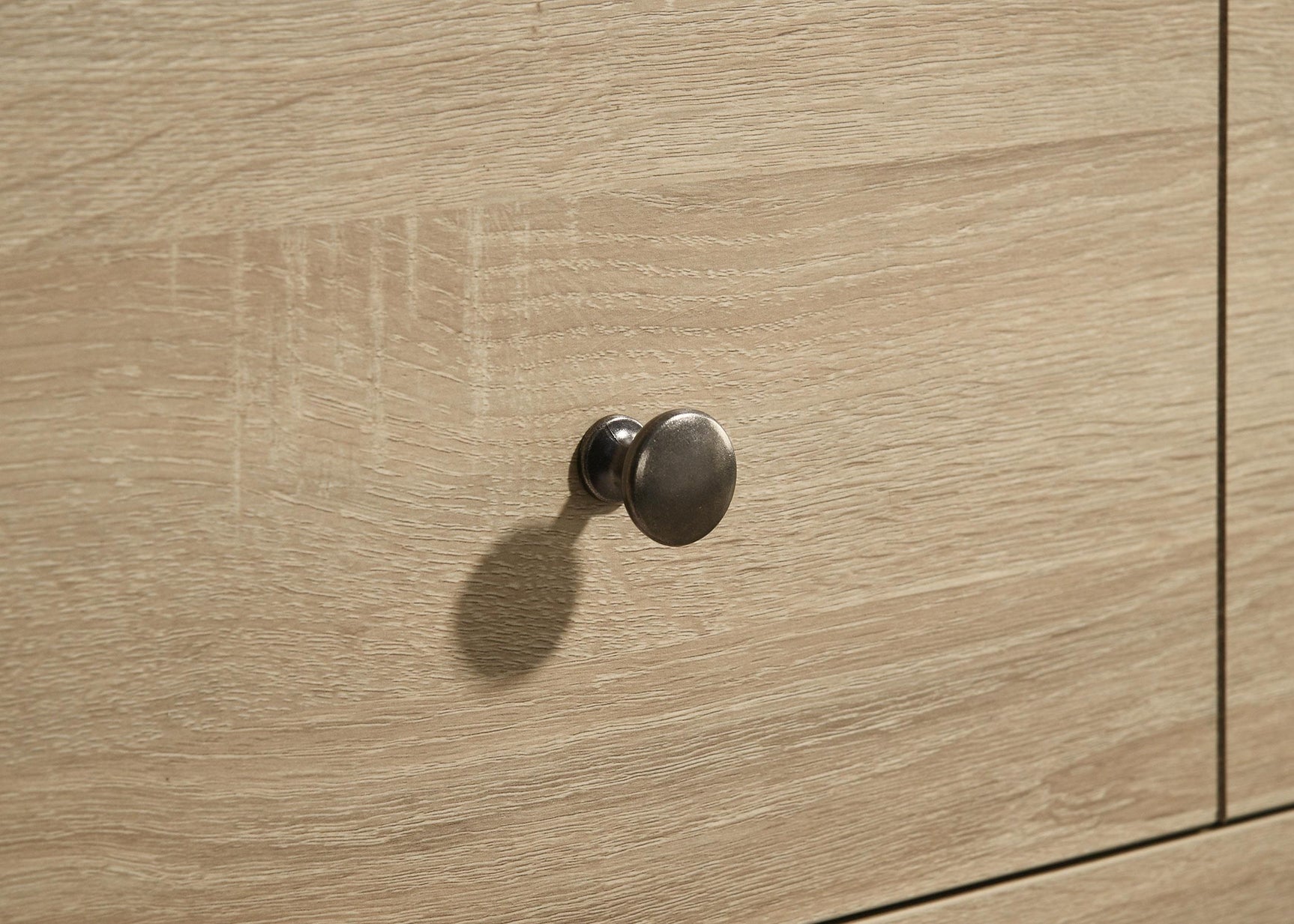 Engineered wood grain detail on dresser surface