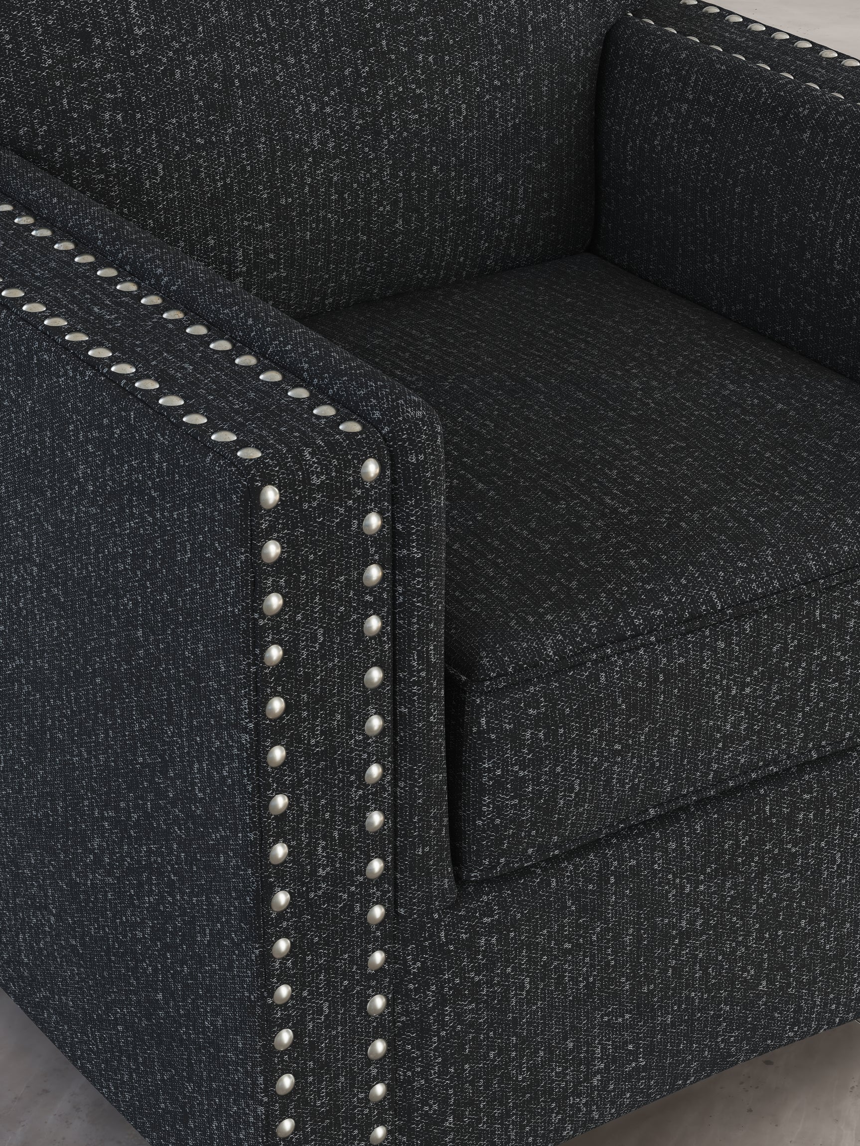 Detail close-up of chenille fabric and nailhead trim