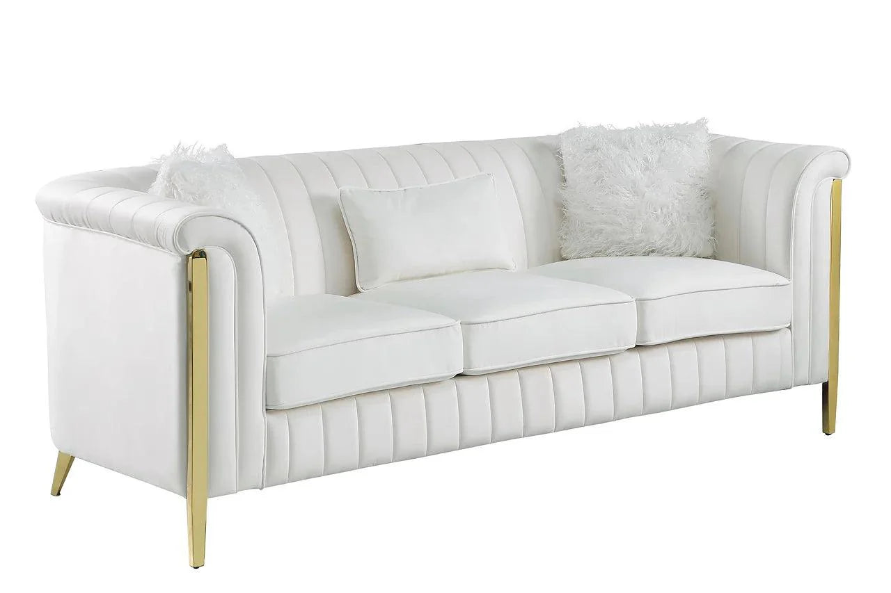 Close-up detail of cream velvet upholstery and gold legs on living room set