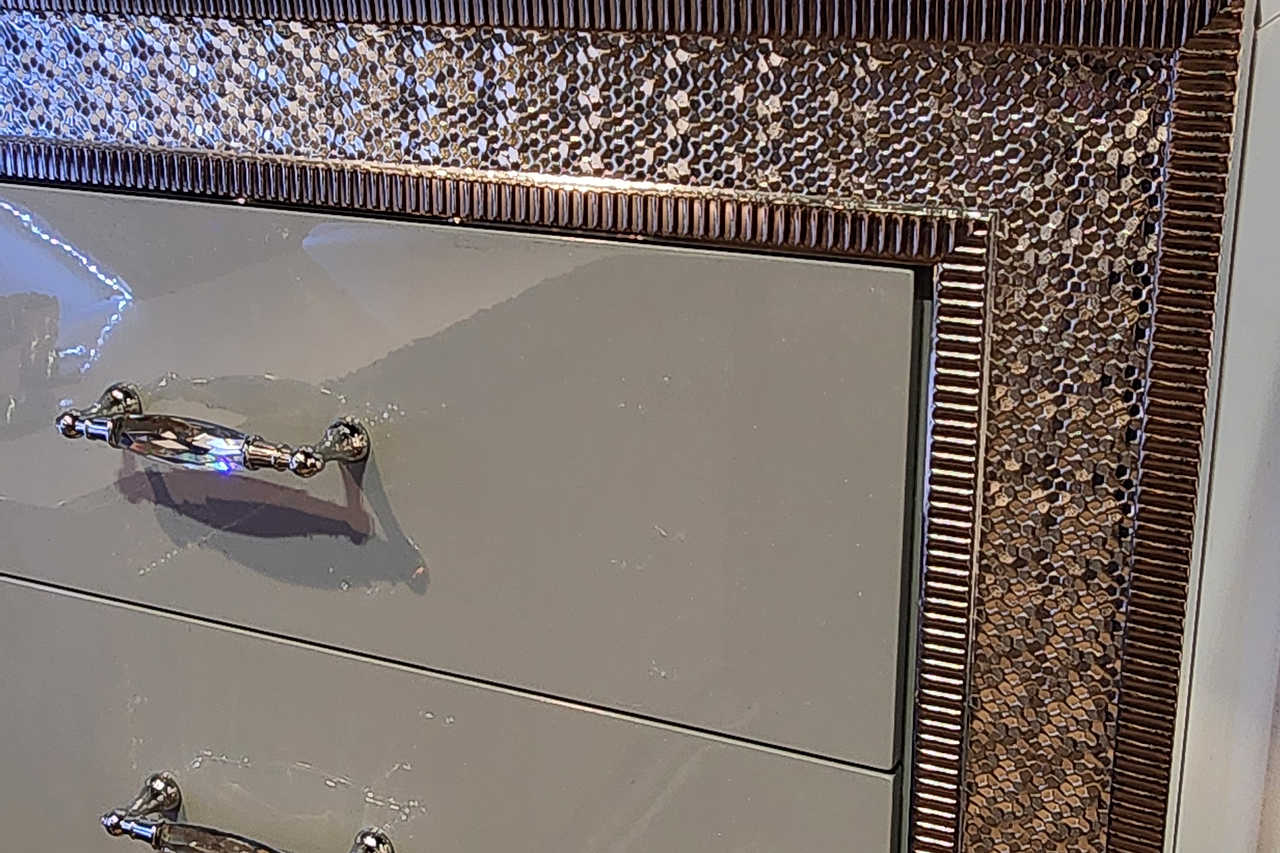Metallic silver chest staged in bedroom