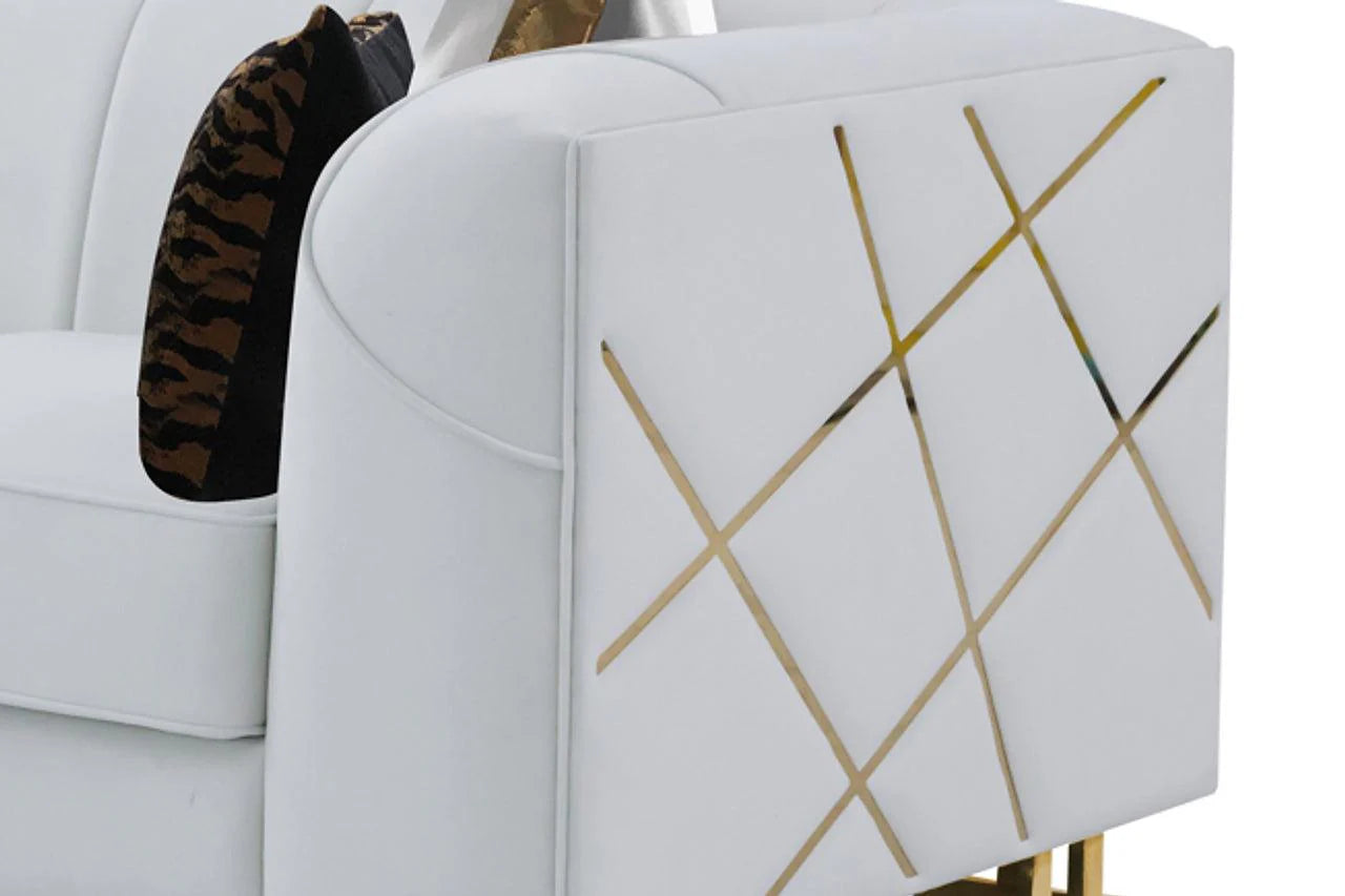 Side view of off-white velvet sofa with gold accents