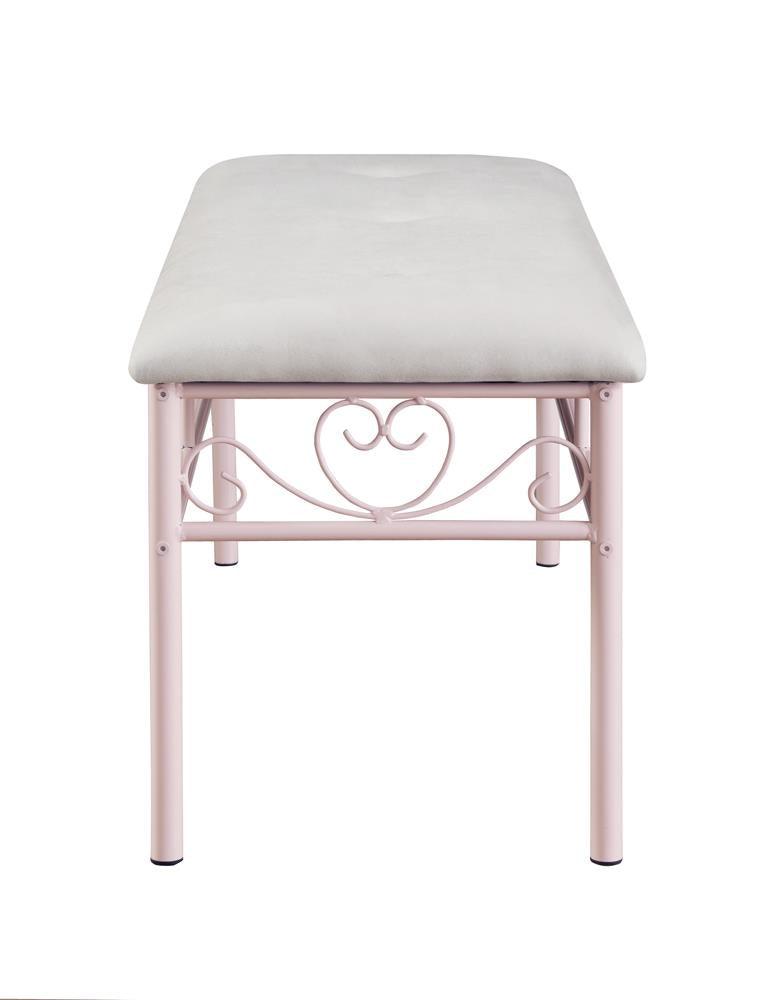 Detail of antique bronze nailhead trim on powder pink bench