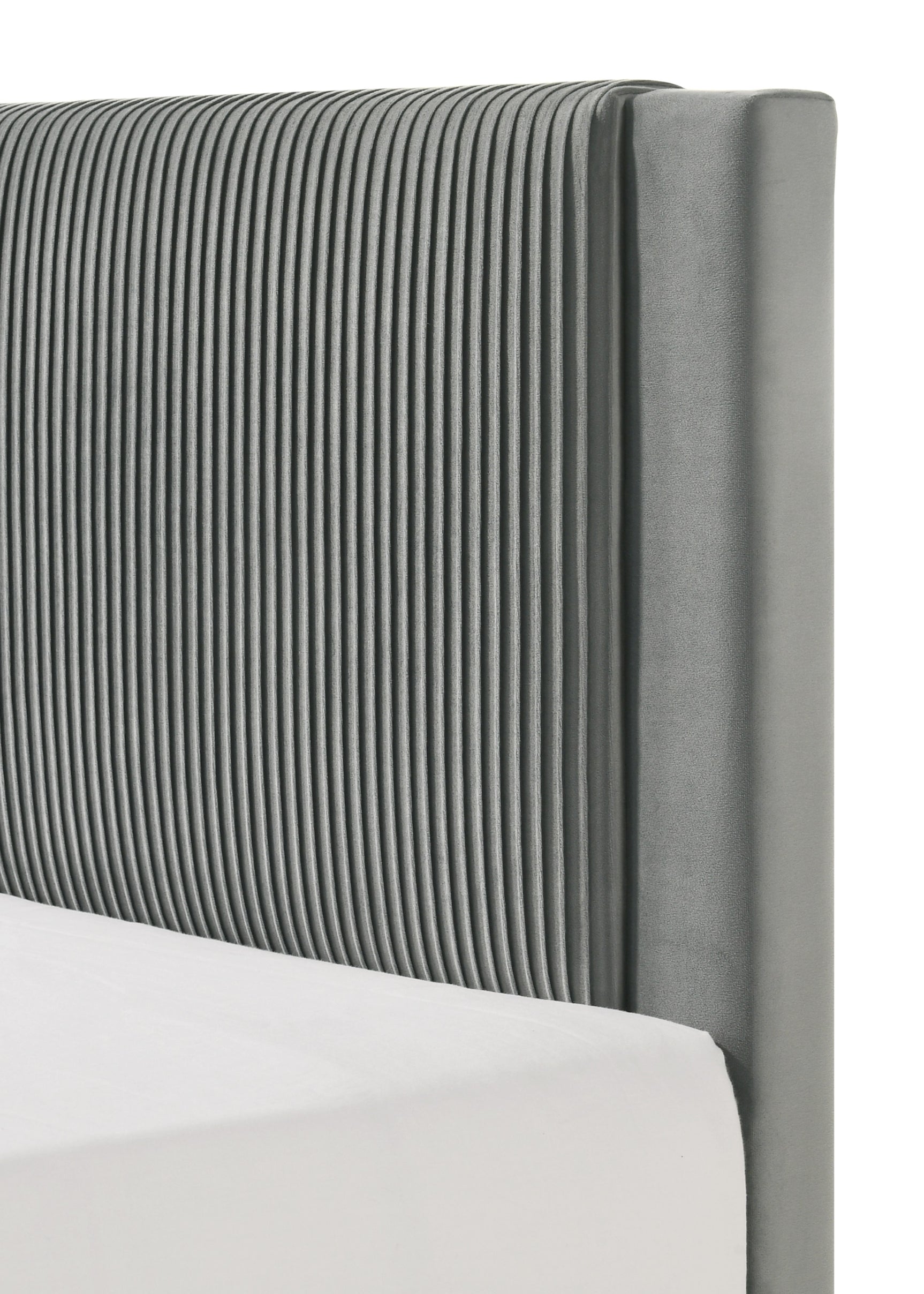 Bed frame corner showing light gray upholstery