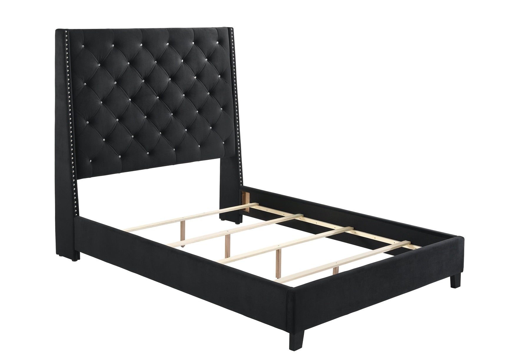 Close-up of tufted black velvet headboard and crystal buttons