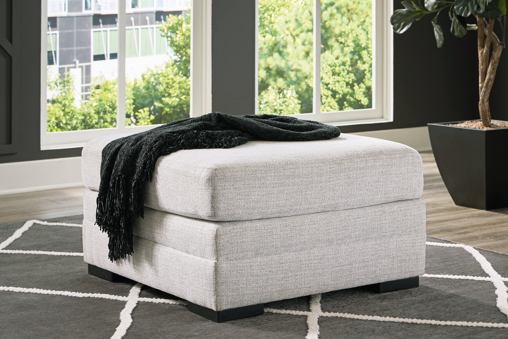 room view showing sectional and ottoman arrangement