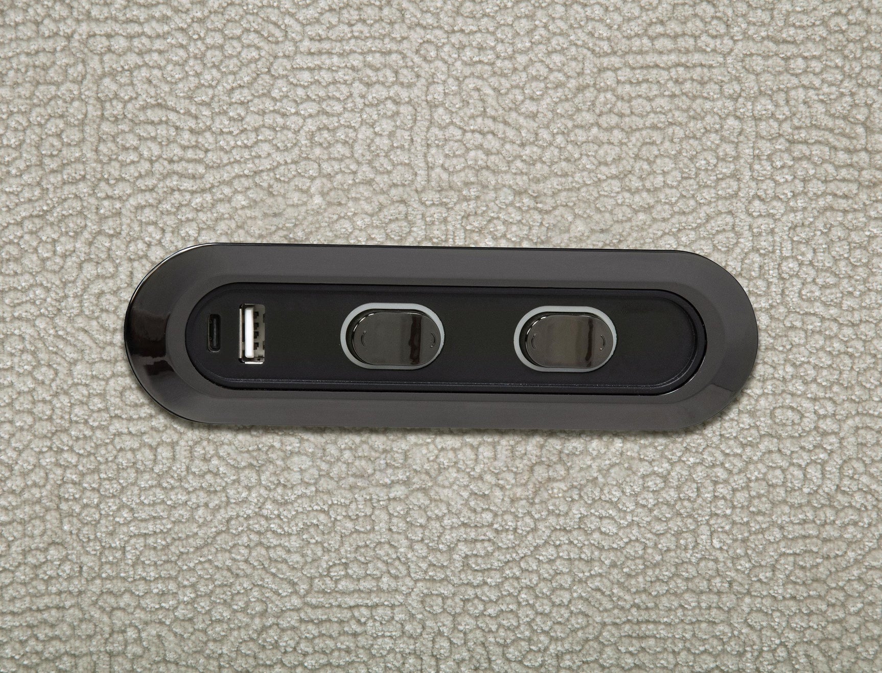 Close-up of ivory chenille upholstery and power recliner control