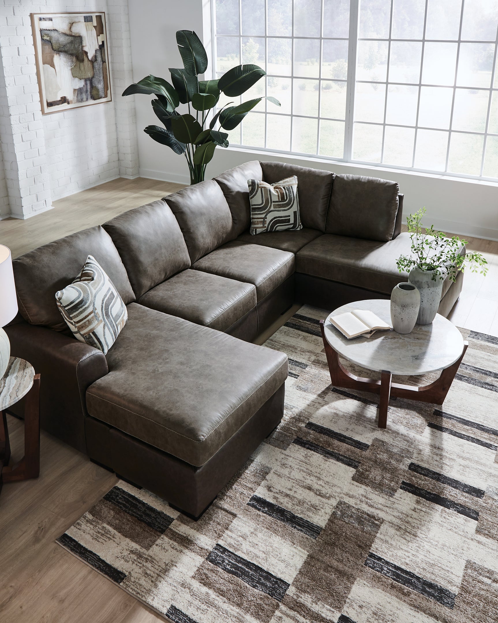 Living room setup featuring Castille Way Fossil 2-Piece Sleeper Sectional with Chaise
