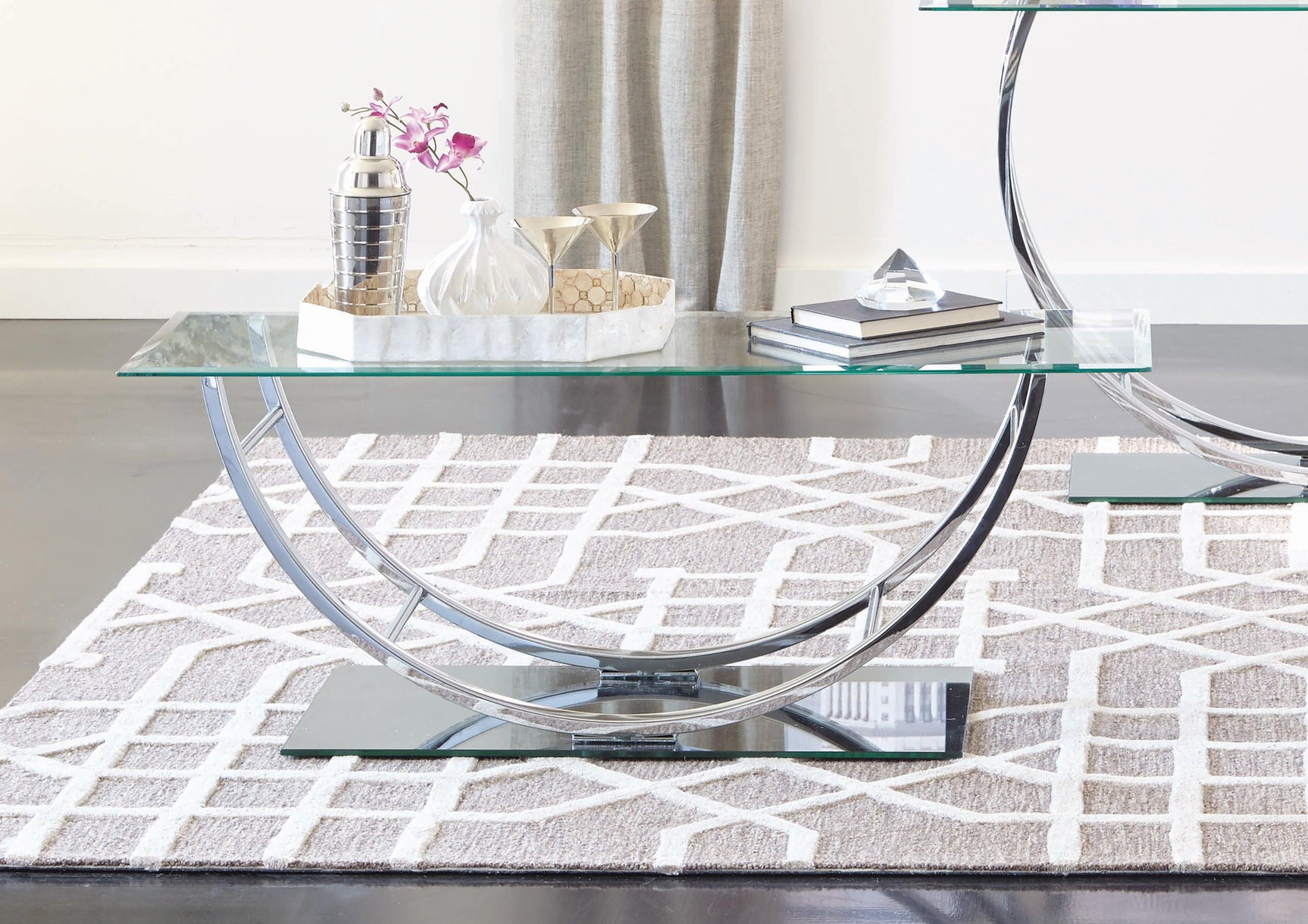 Side angle showing the U-shaped chrome legs and mirrored glass base panel