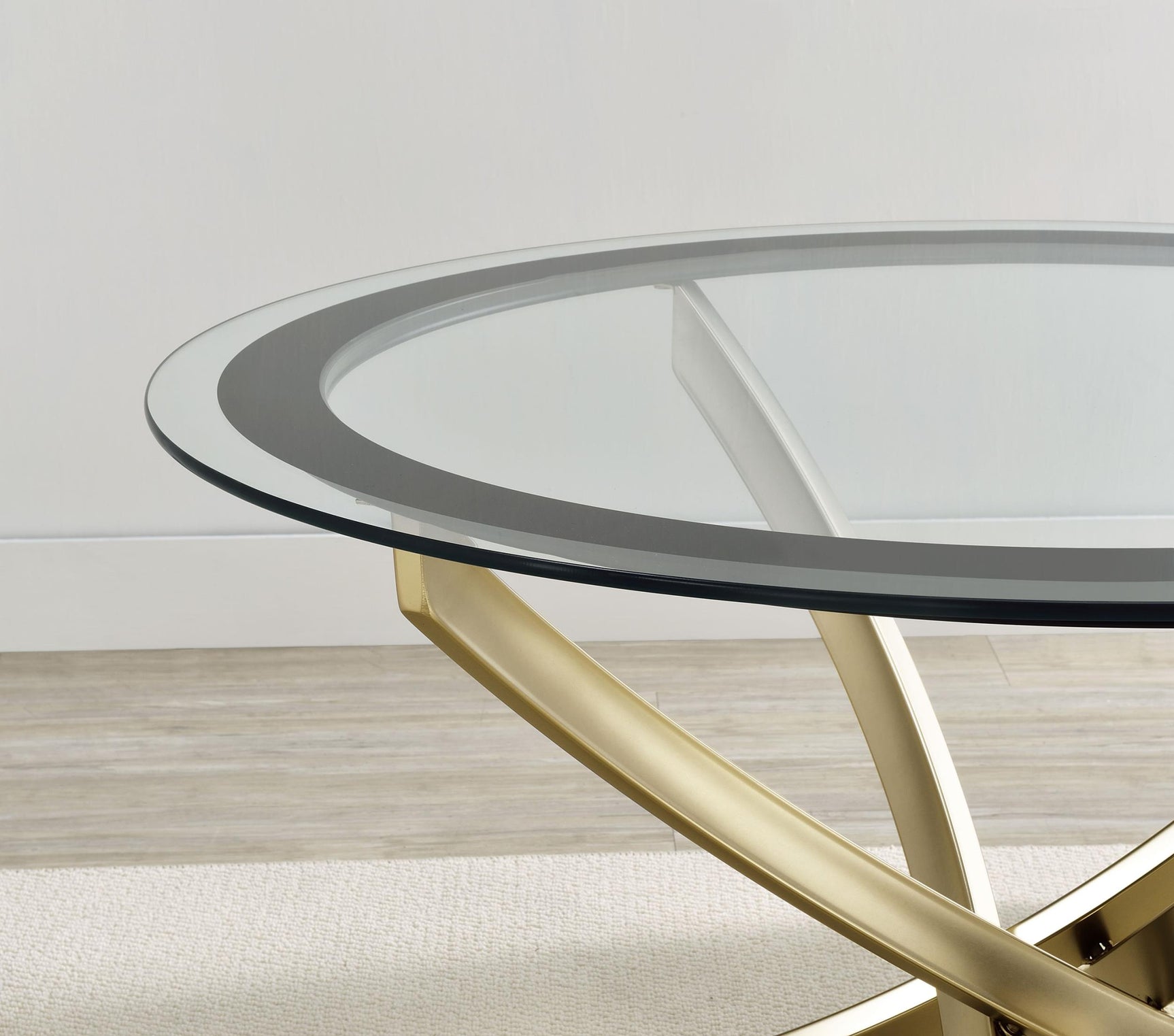 Brooke end table angled view showing curved brass legs and black bordered glass top