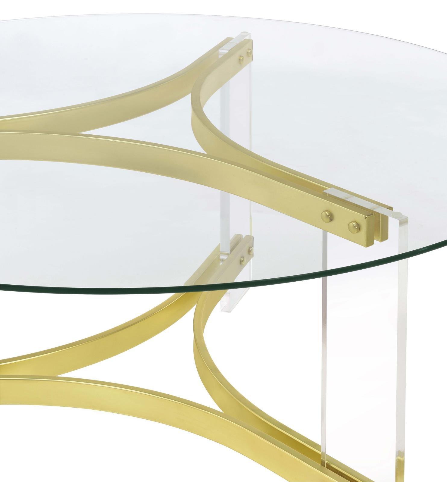 Modern round coffee table with brass legs in living room