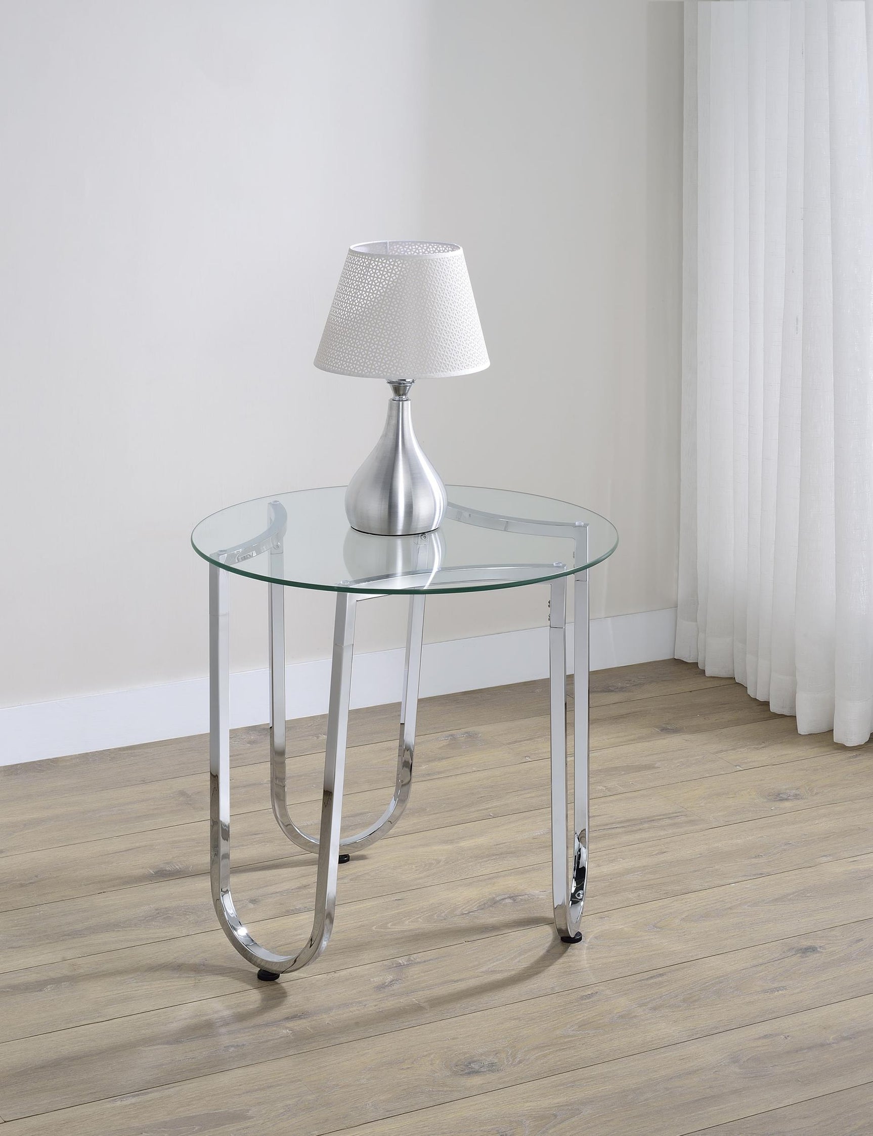 Side view of Beller round chrome side table