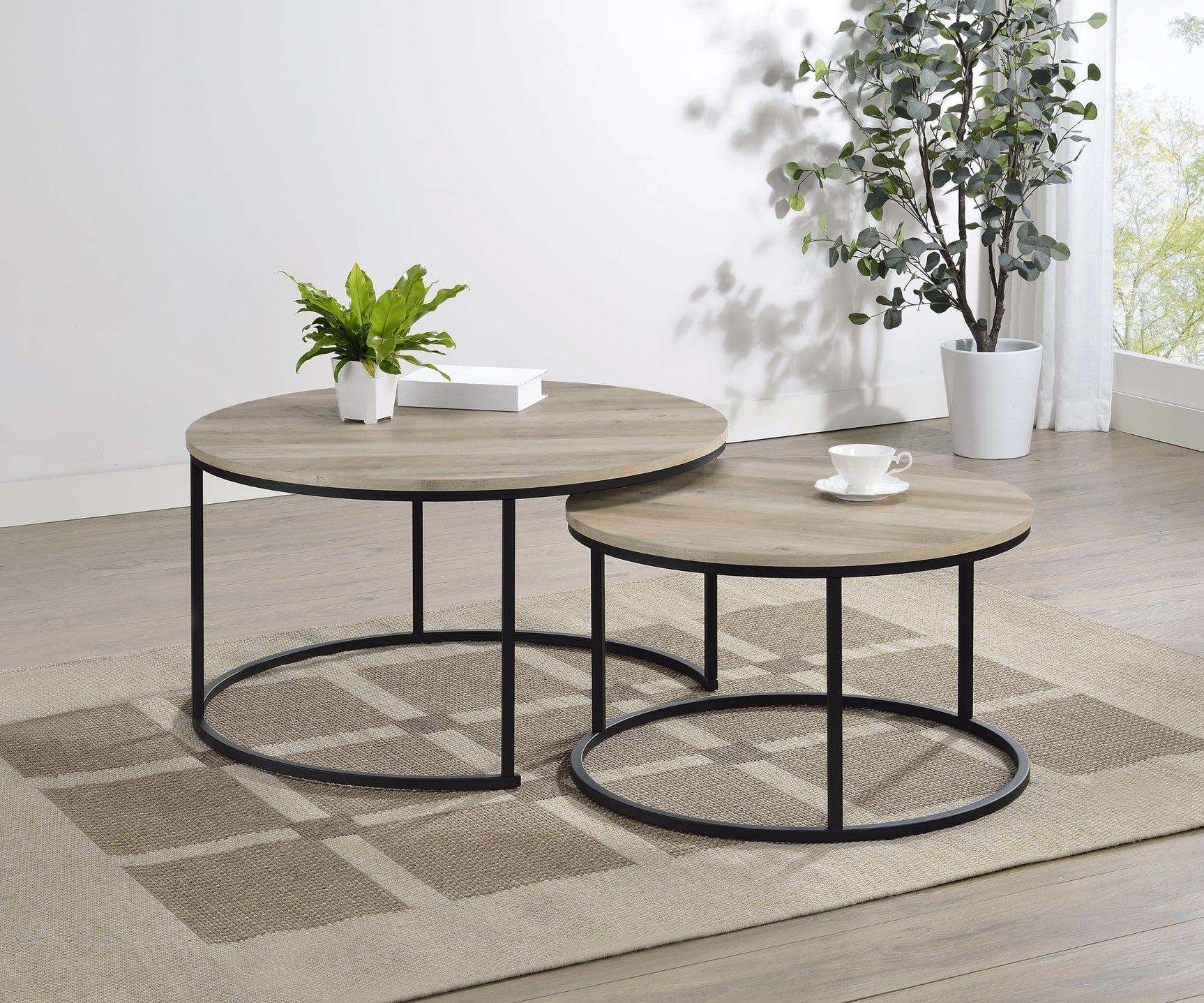Small round nesting coffee table with metal base and distressed pine top