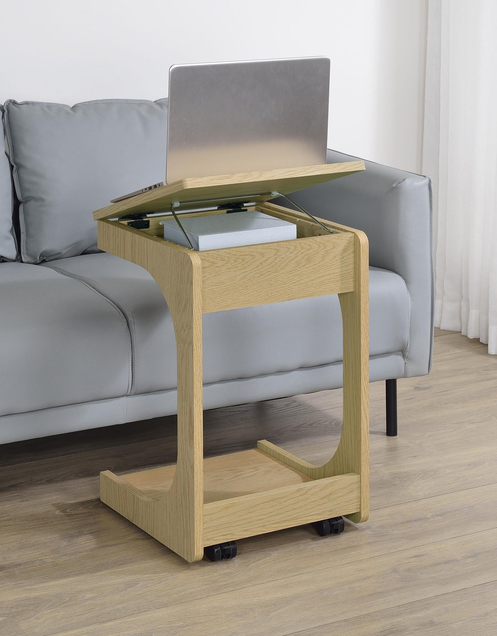 Side view of Ralston C-shaped light oak sofa side table on casters