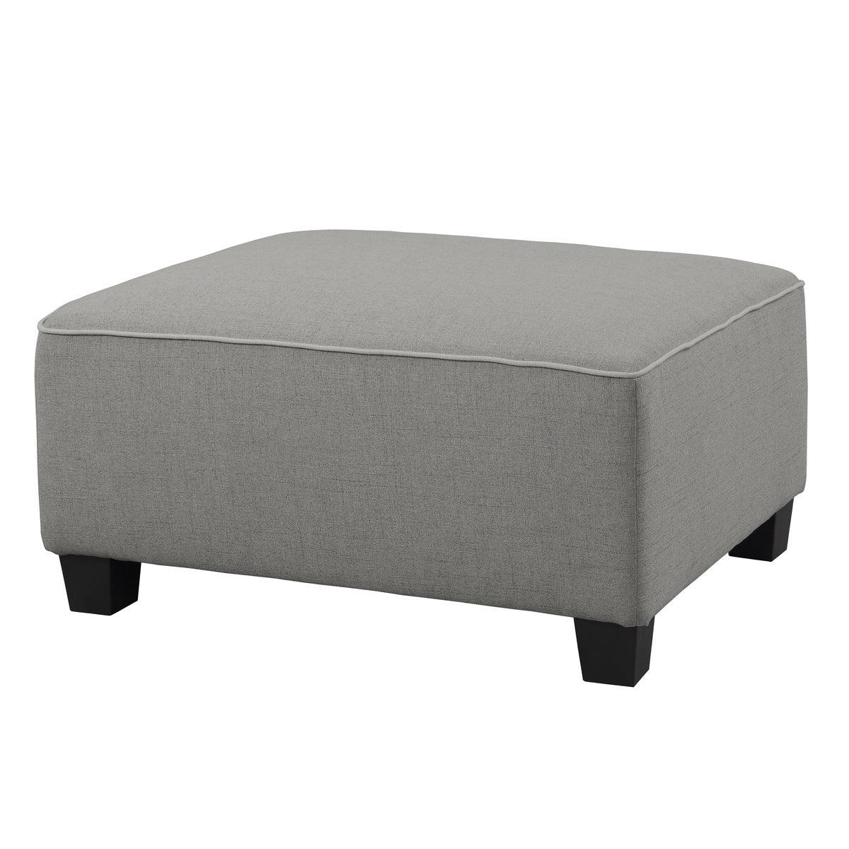 Jayne Gray side view of gray fabric ottoman with faux wood feet