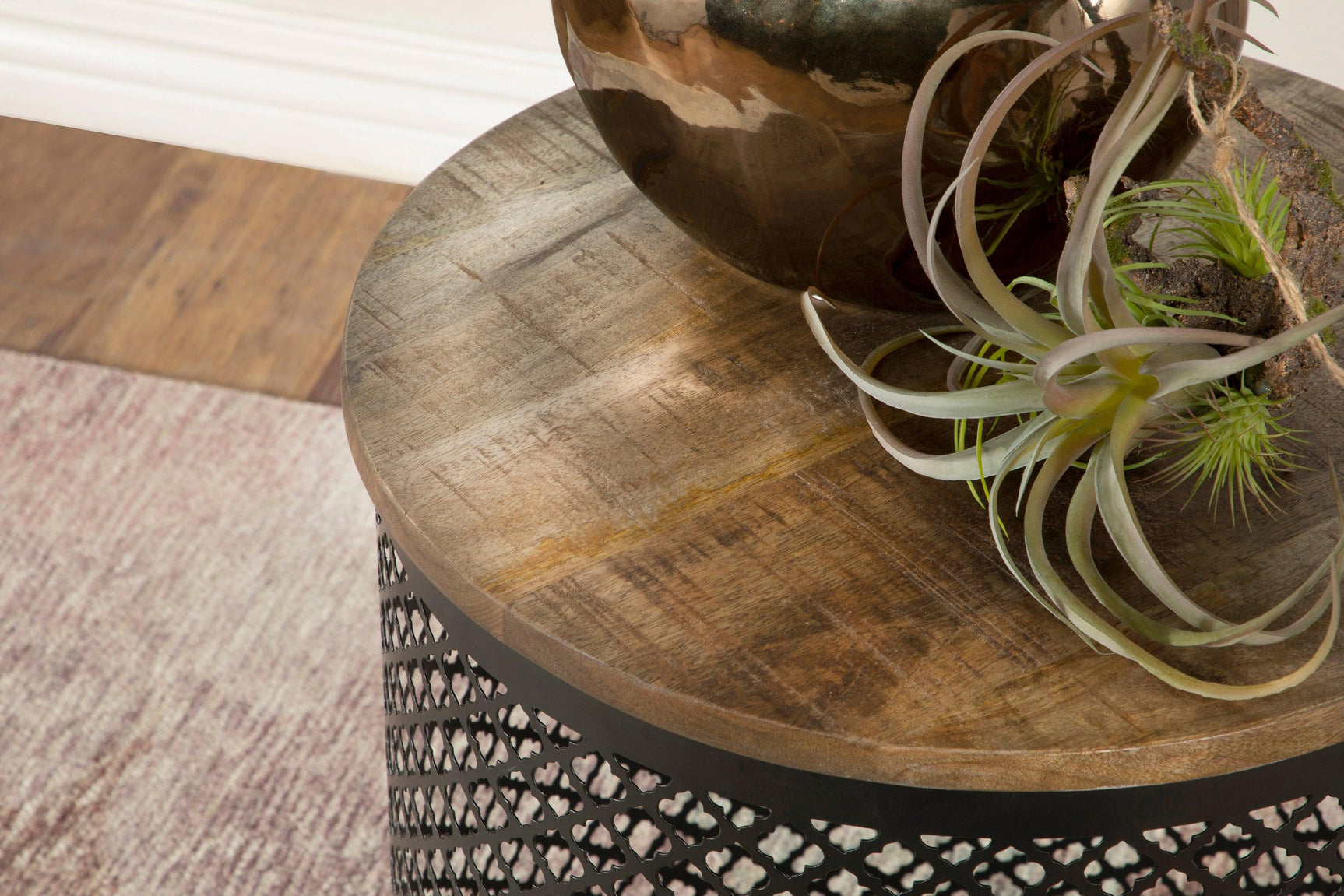 Close-up of mango wood tabletop finish on Aurora Round Accent Table