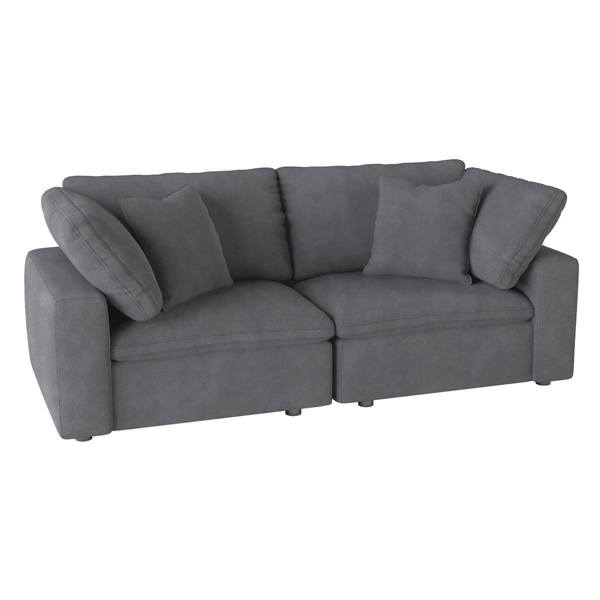 Side angle of gray microfiber upholstered love seat with pillows