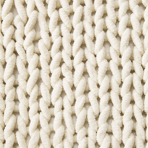 Chaddon Ivory Throw set of 3 folded on sofa