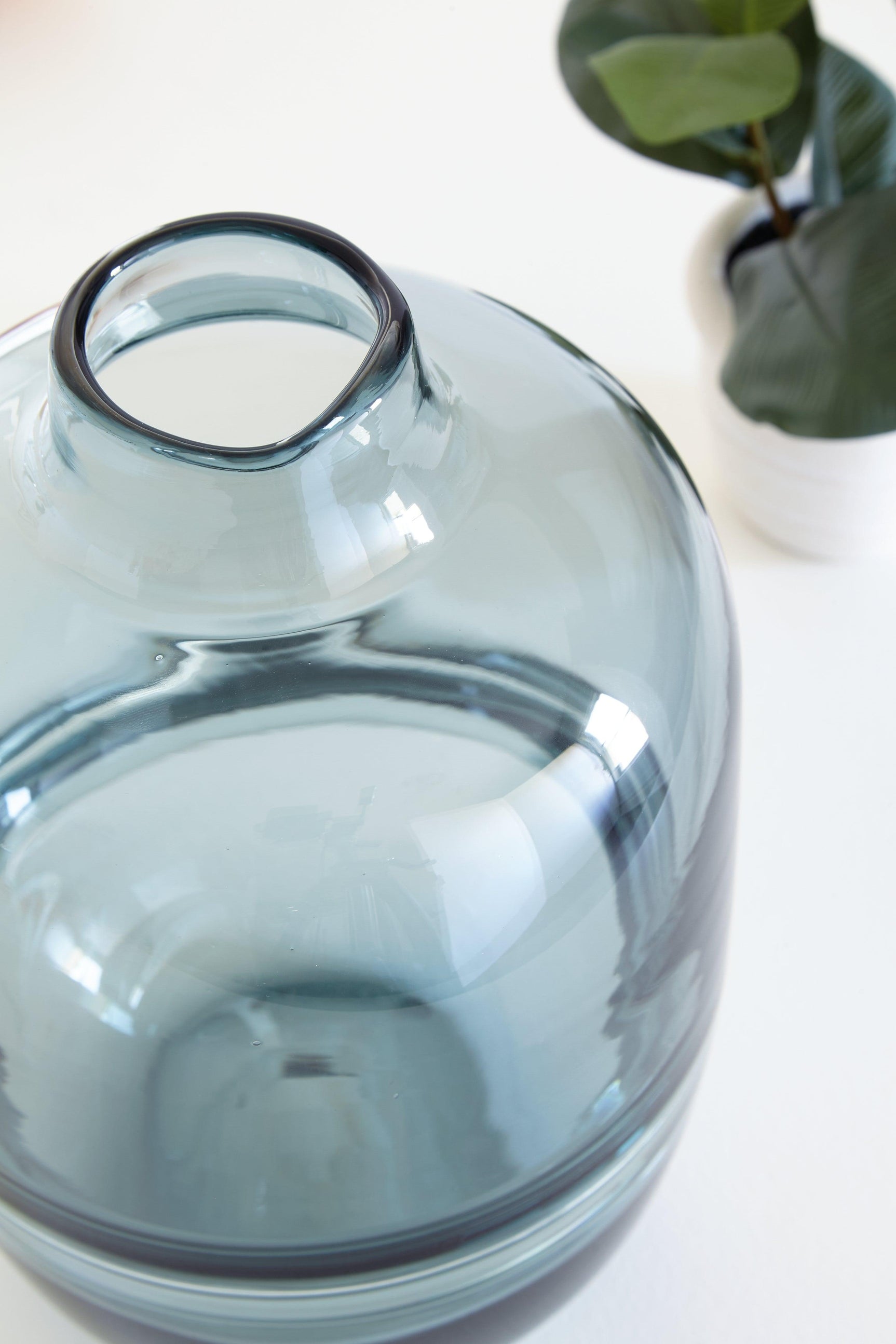 Close-up of glossy teal glass finish on Lemmitt vase