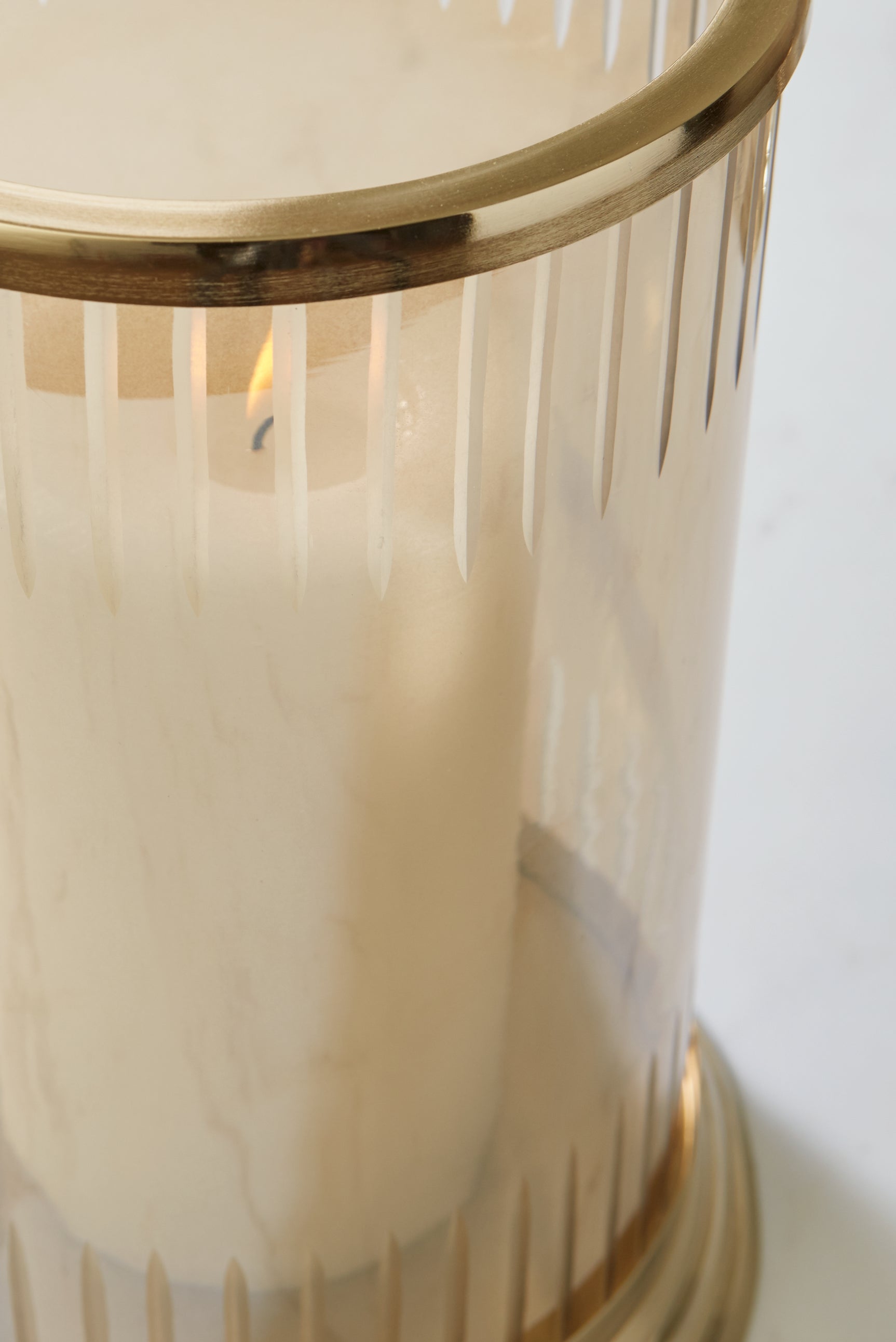 Close-up of amber carved glass on candle holder