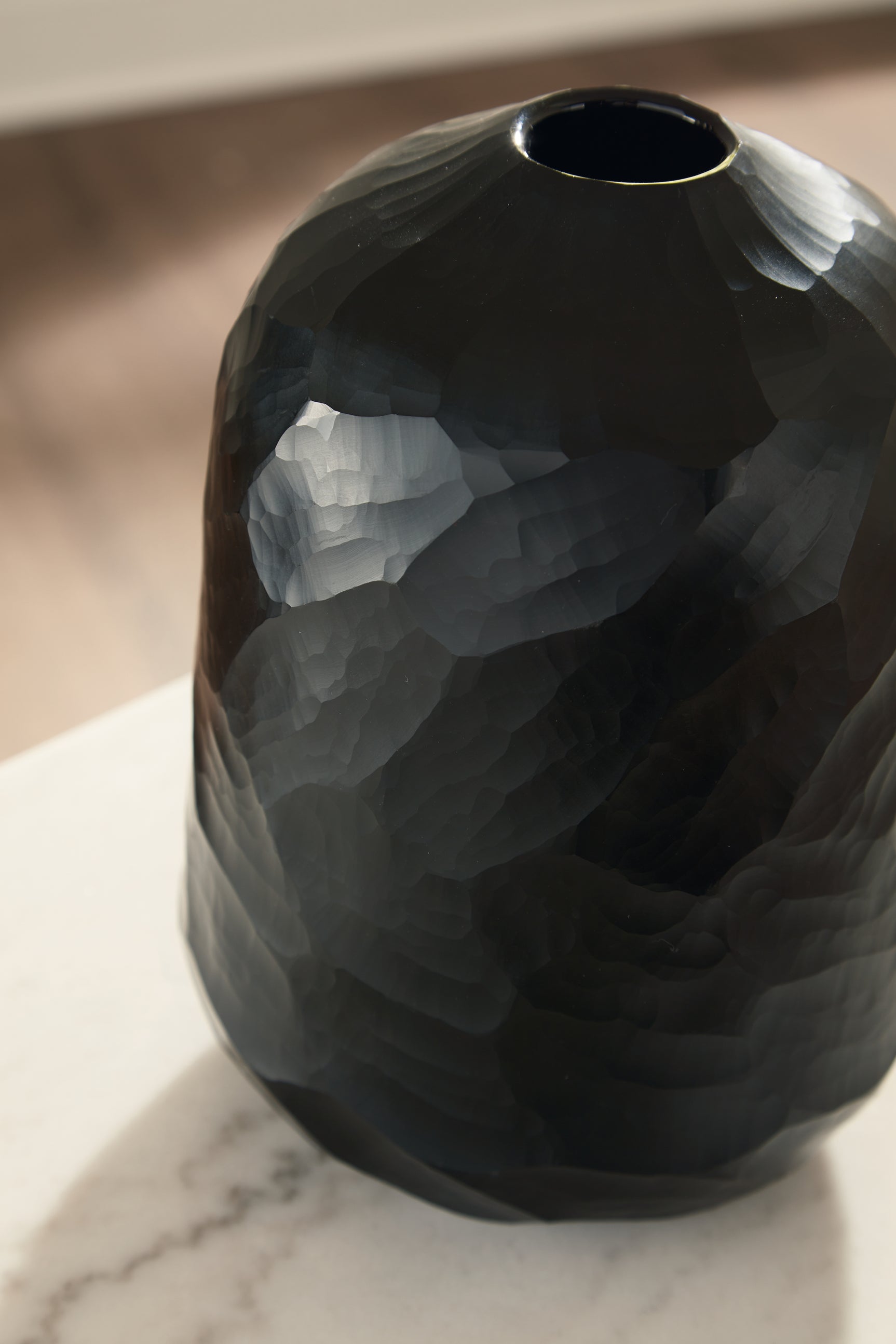 Close-up of Ryanford Vase hand-carved black glass surface