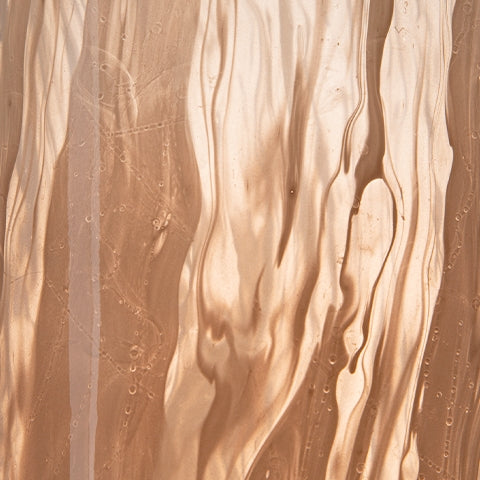 Close-up of flowing swirl pattern on blush pink vase