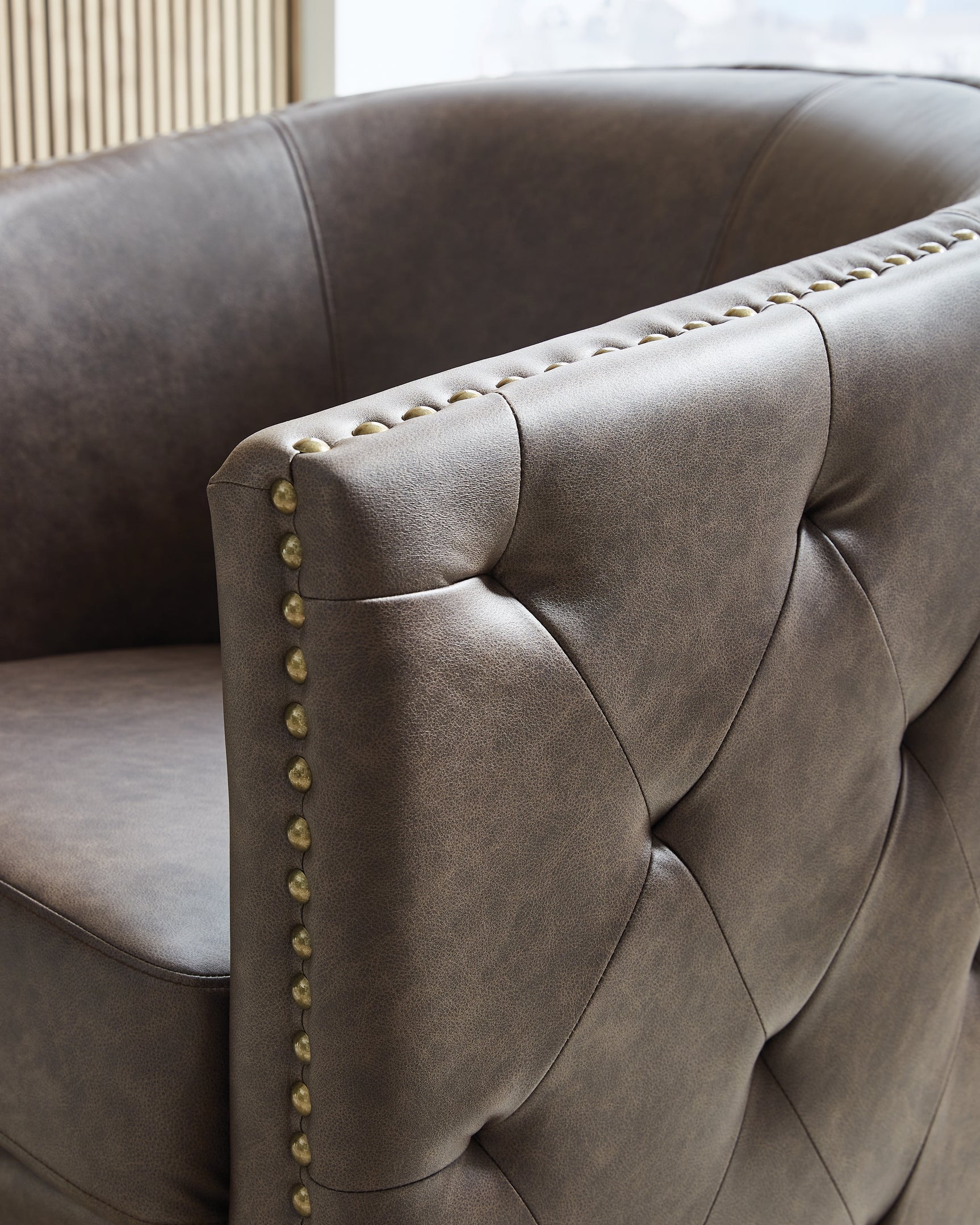 Detail of antiqued brass nailhead trim on Brentlow Chair