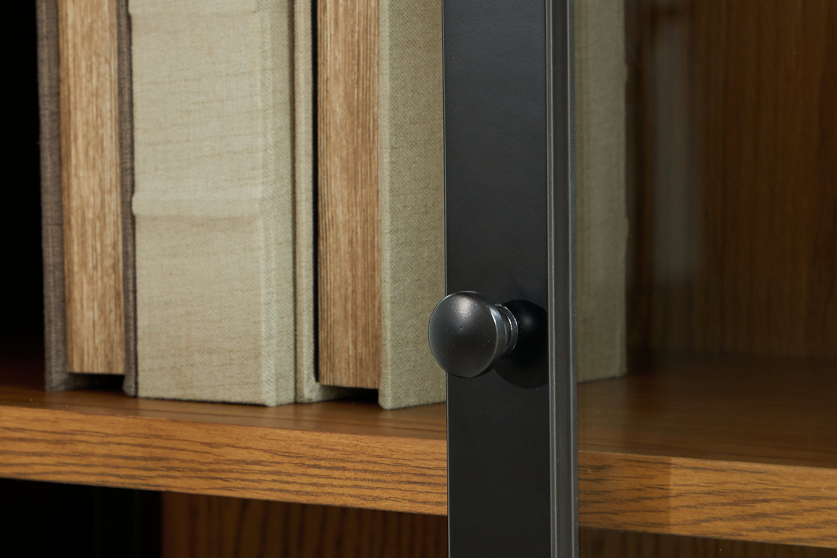 Close up of black wood door pull on Dagandale Accent Cabinet