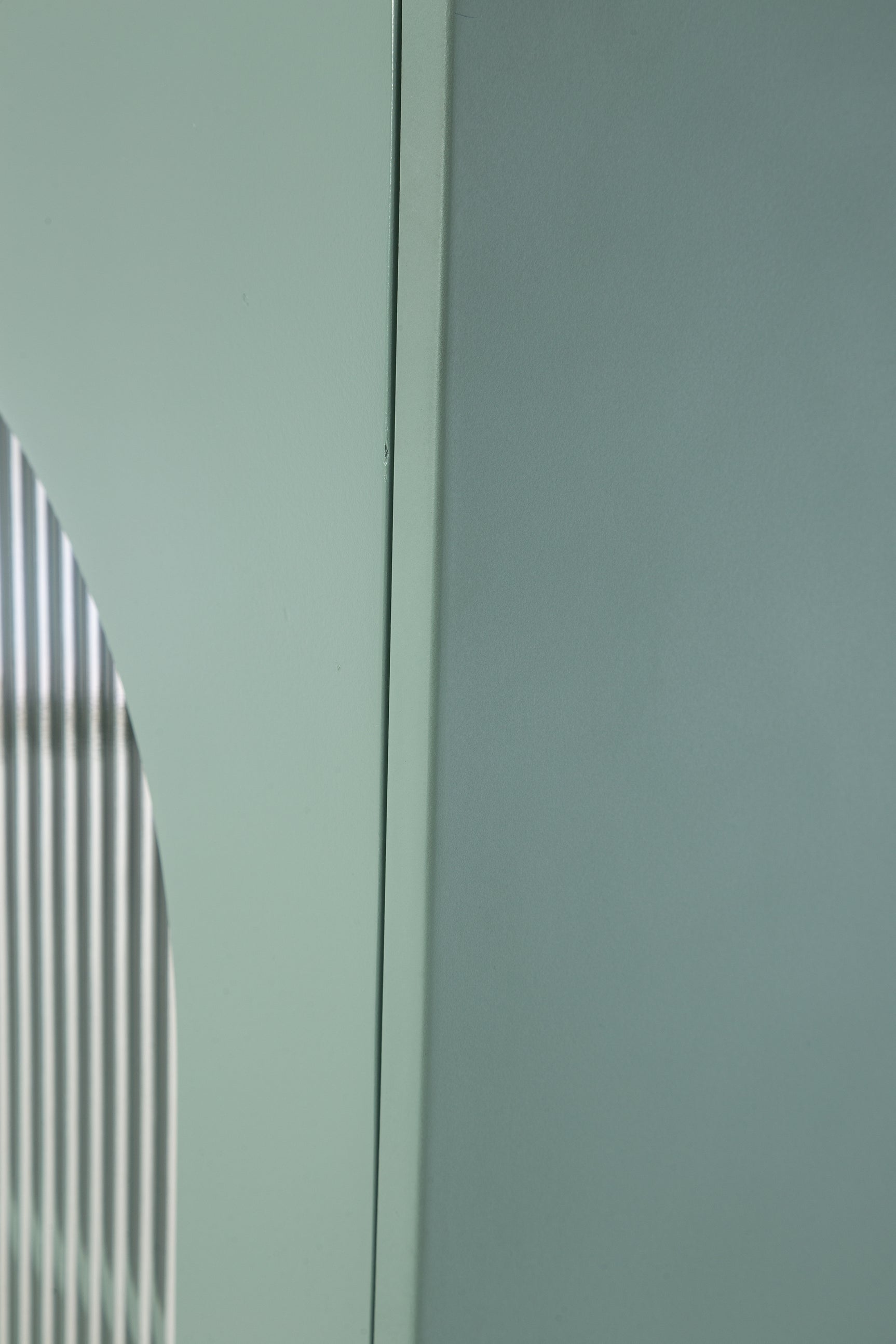 Detail of light green finish texture on Adwen cabinet
