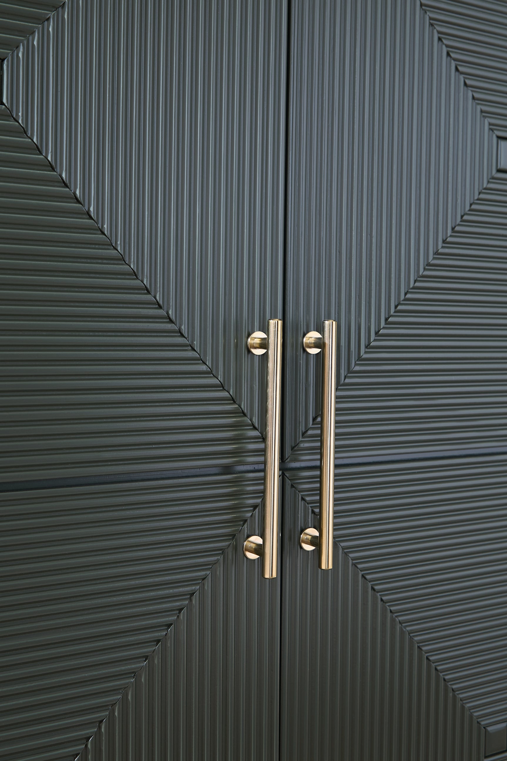 Close-up of Geirwood cabinet goldtone handle detail
