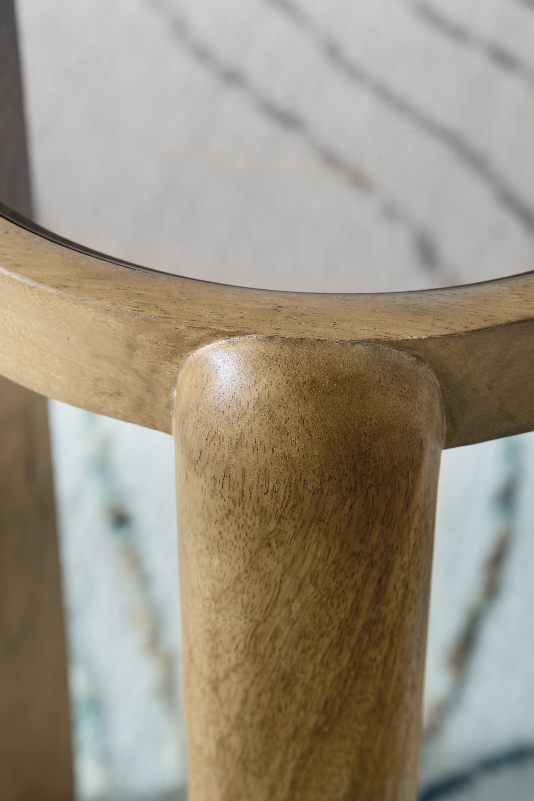 Top view of light brown glass tabletop on Jossor accent table