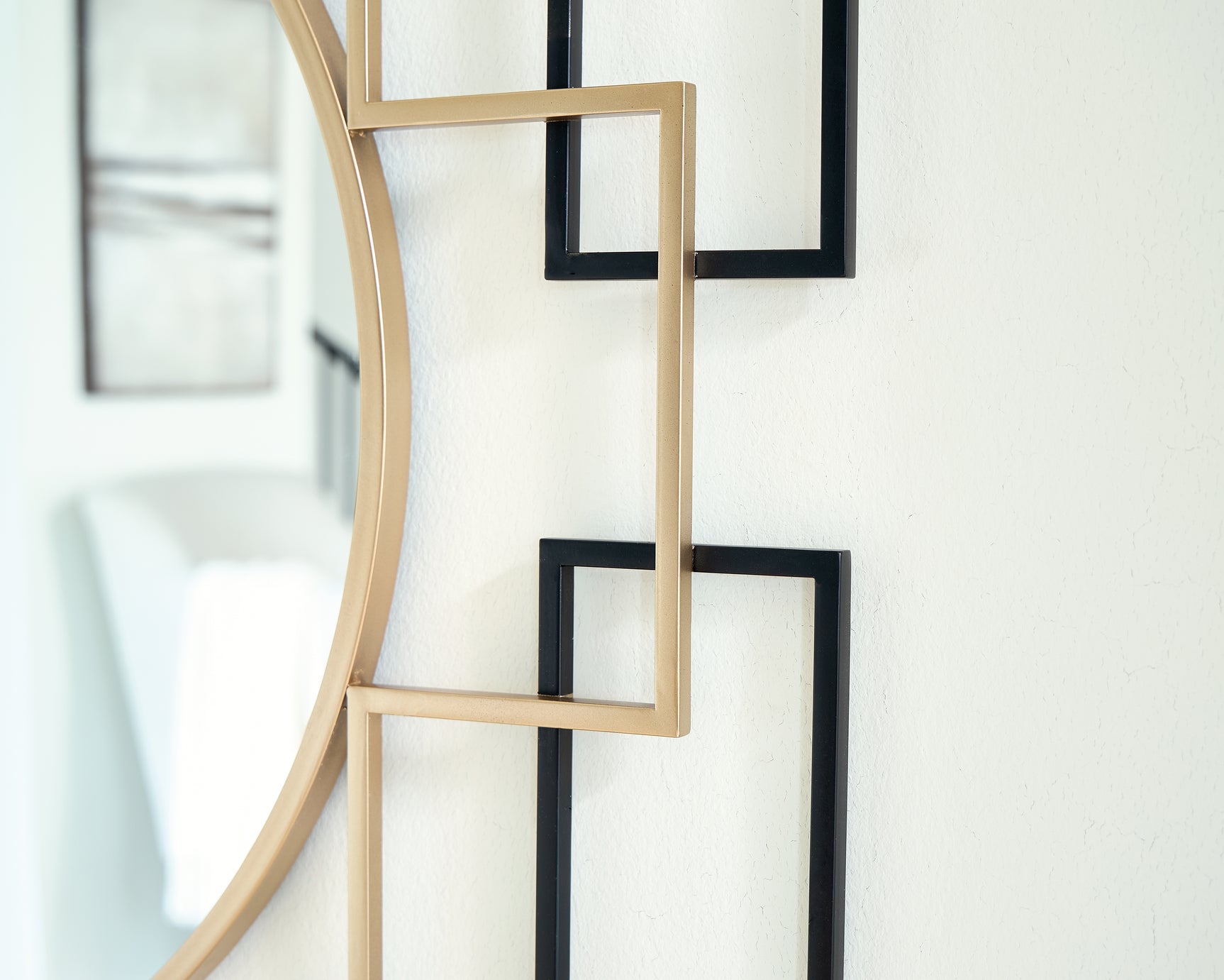 Oceanal accent mirror, close-up detail of black and gold finish frame